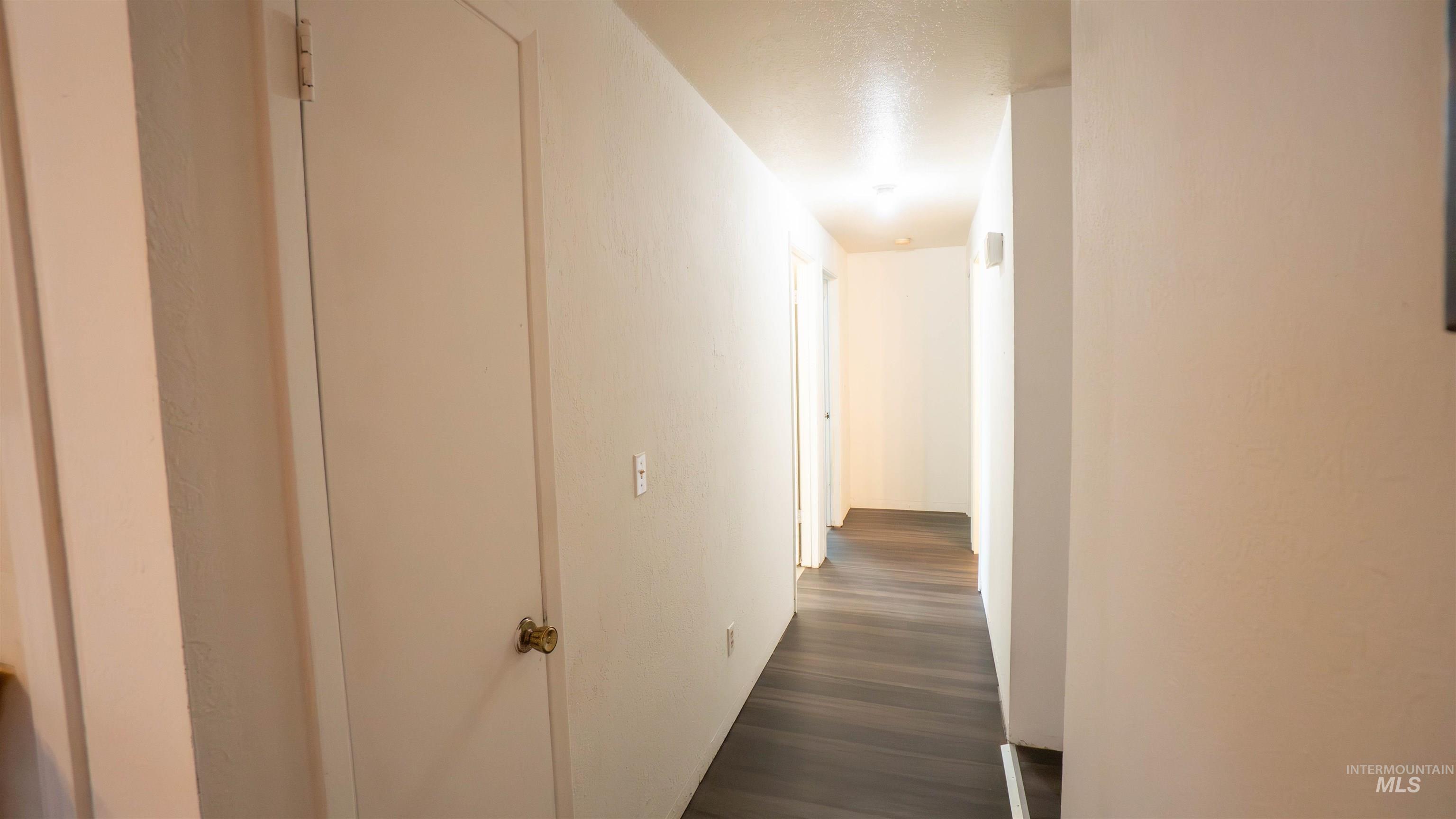 Hall featuring dark wood-style floors