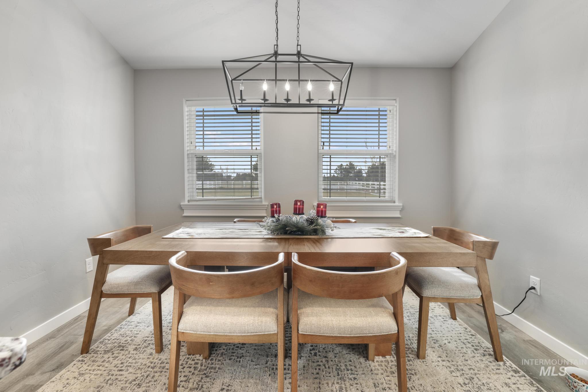Dining space with baseboards and light wood-type flooring