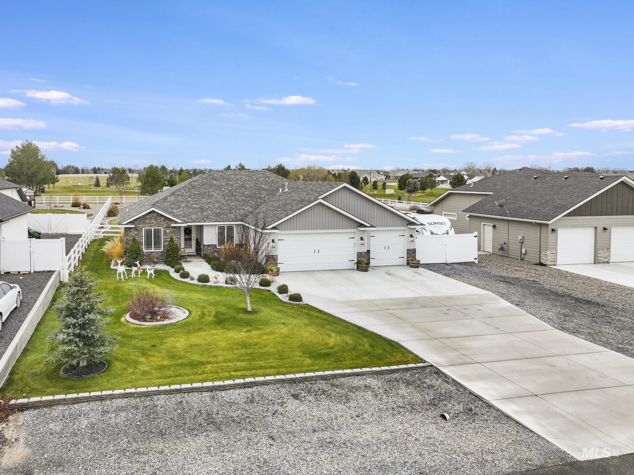View of front of property featuring driveway, a garage, and a residential view
