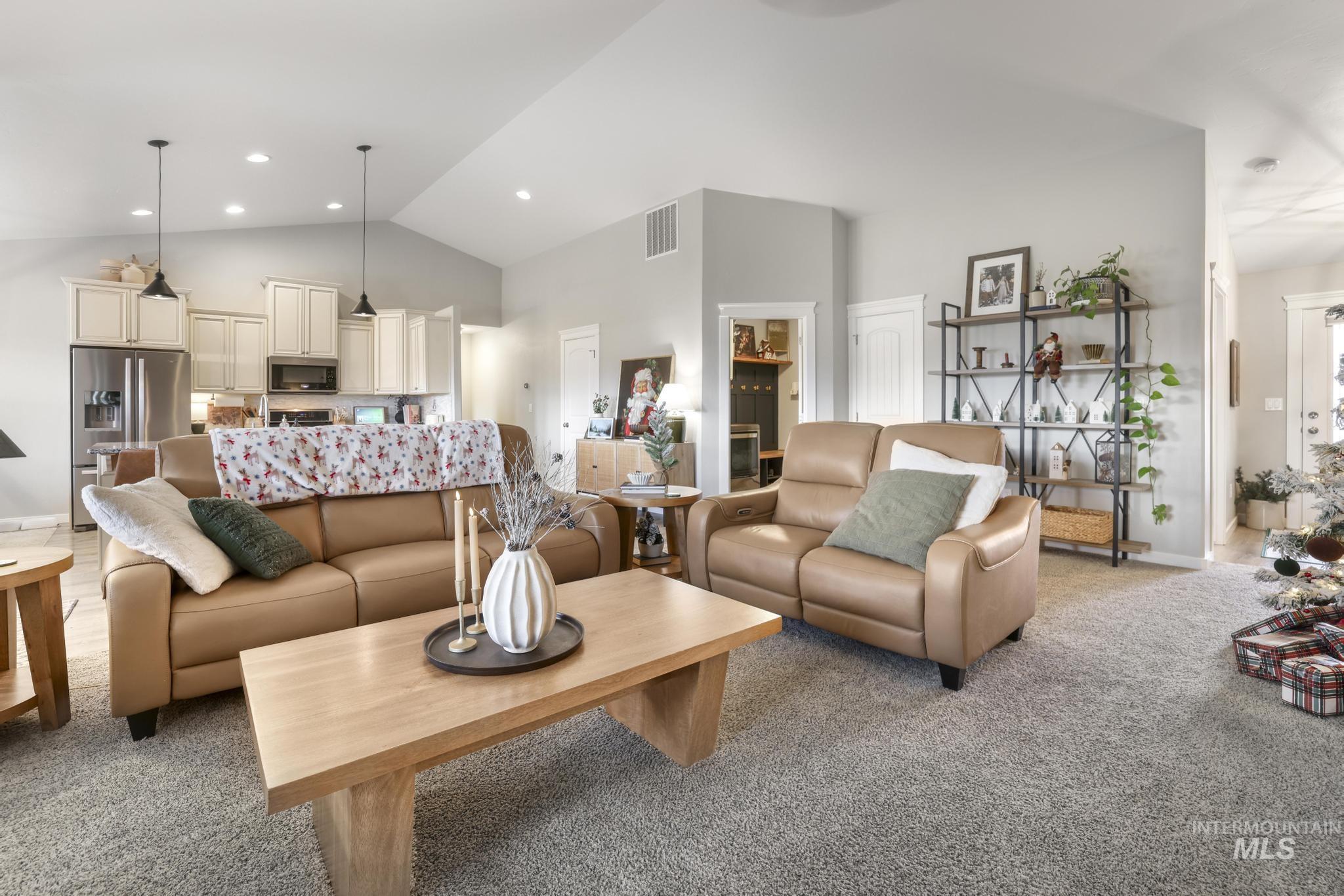 Living room with light carpet and lofted ceiling
