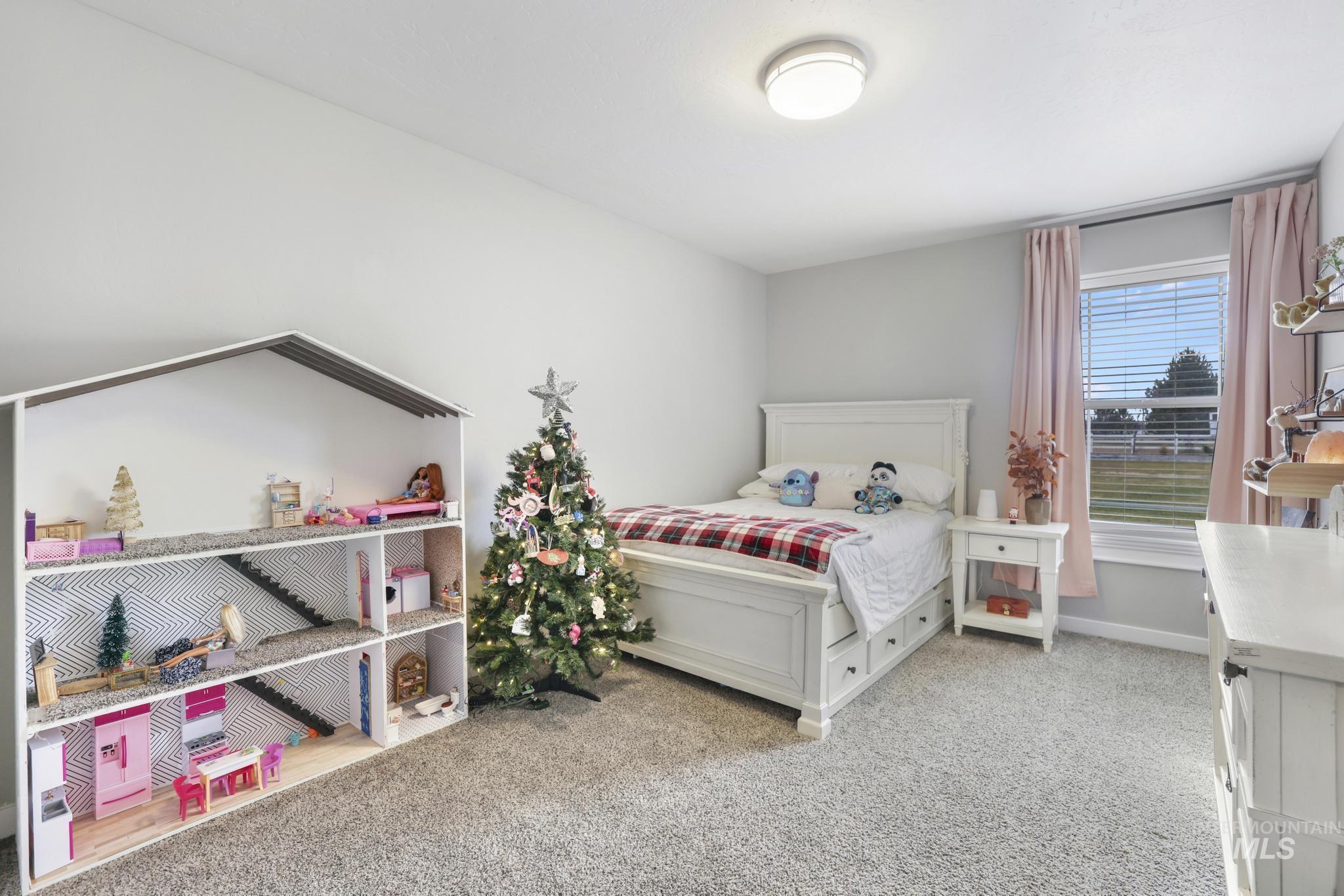 Bedroom with light carpet and baseboards