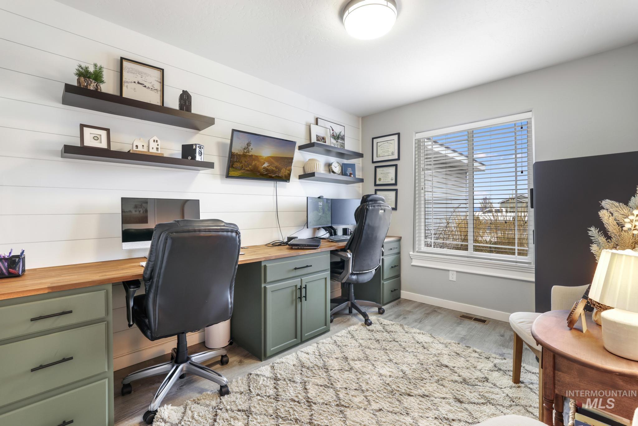 Office area featuring baseboards and light wood-style floors