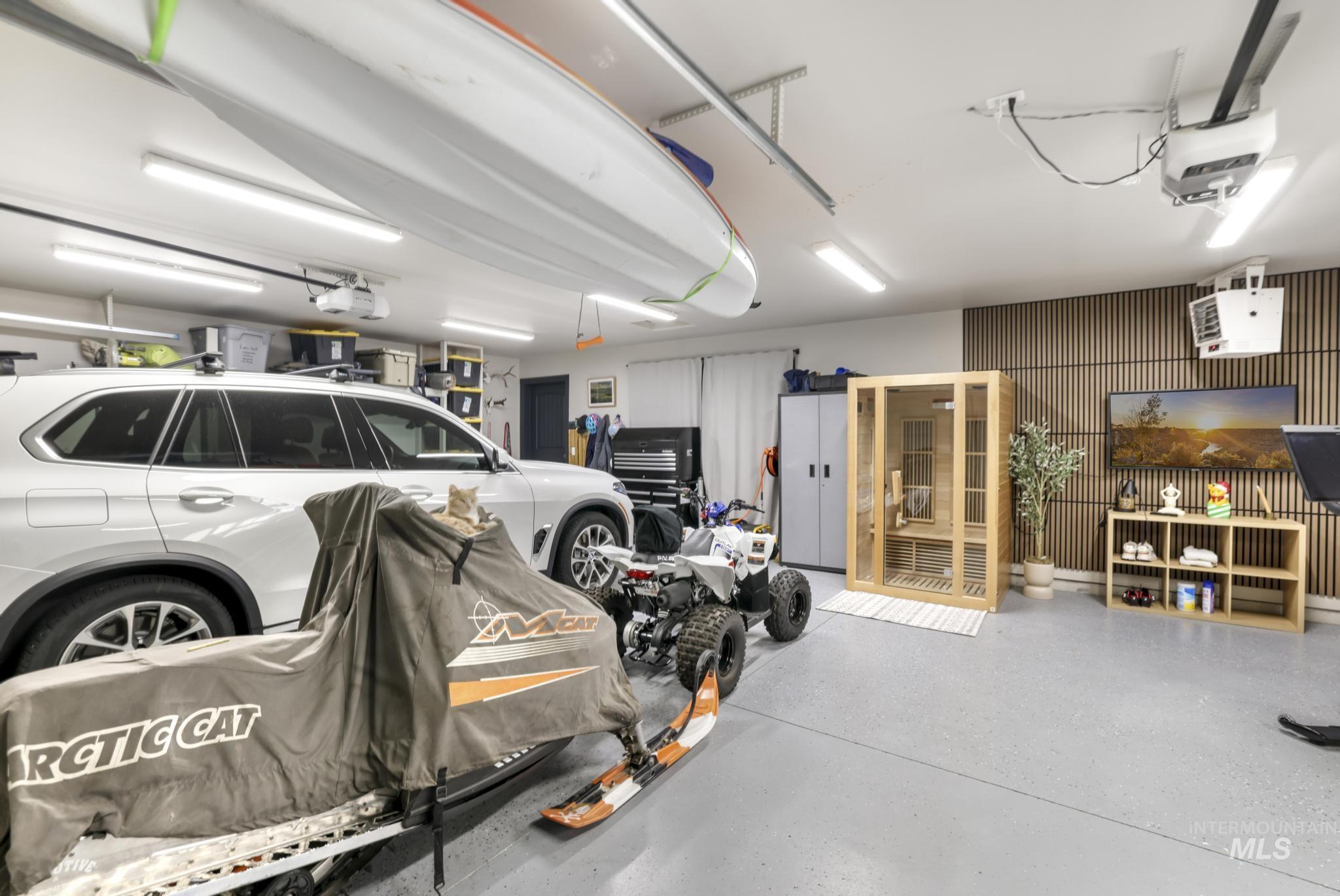Garage featuring a relaxing sauna, a heating unit, and a garage door opener
