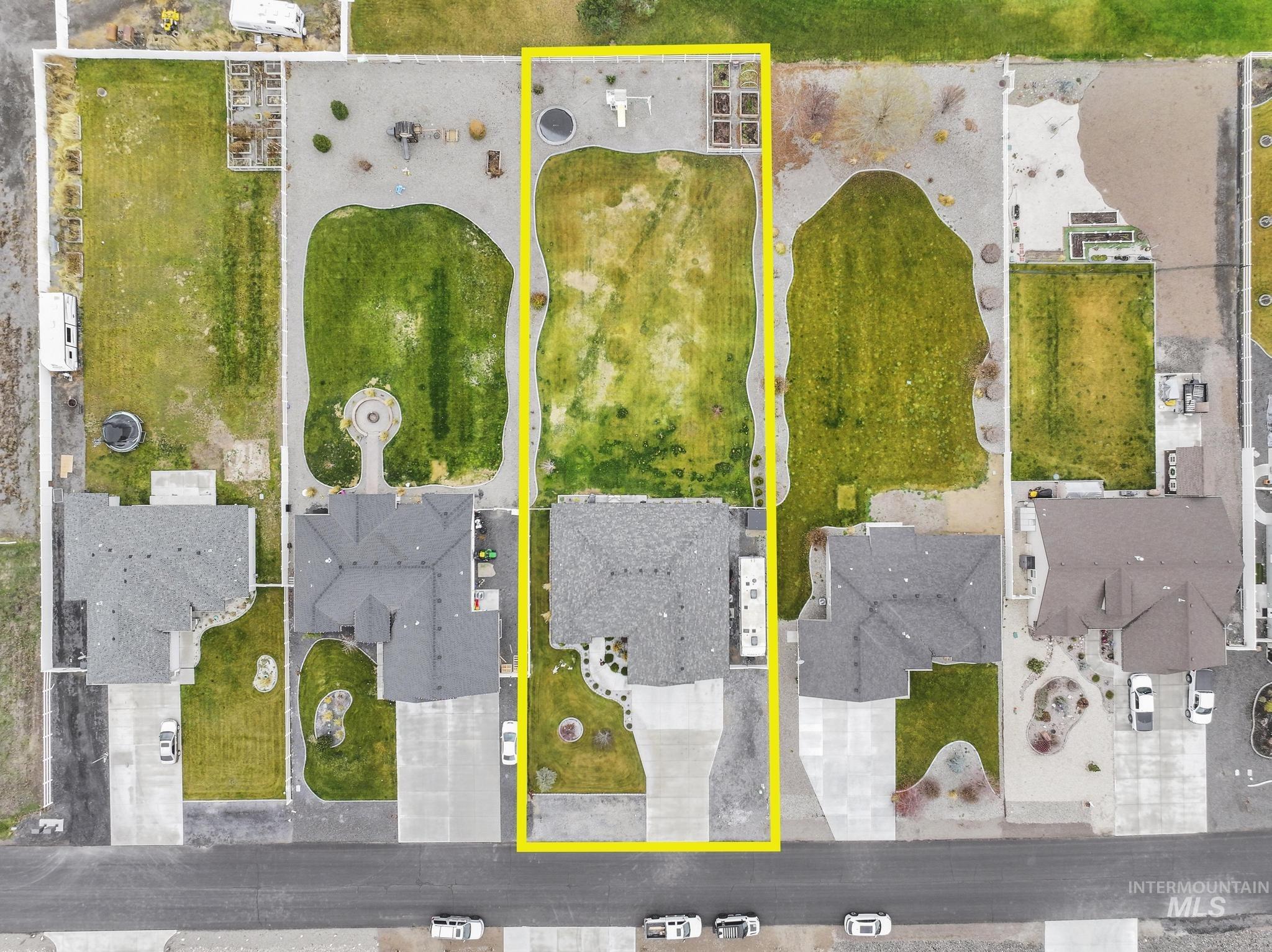 Aerial view of residential area featuring property boundaries highlighted