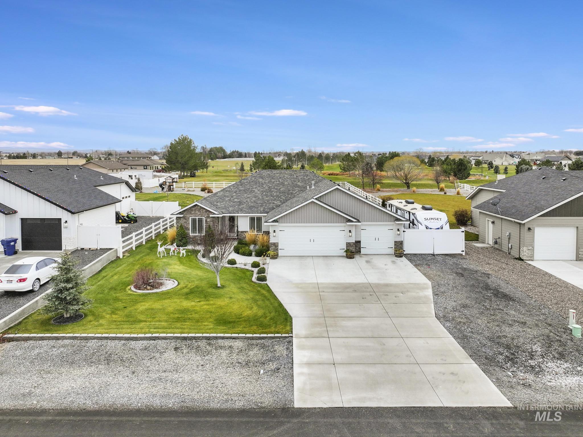 View of front facade featuring concrete driveway, a garage, and a residential view