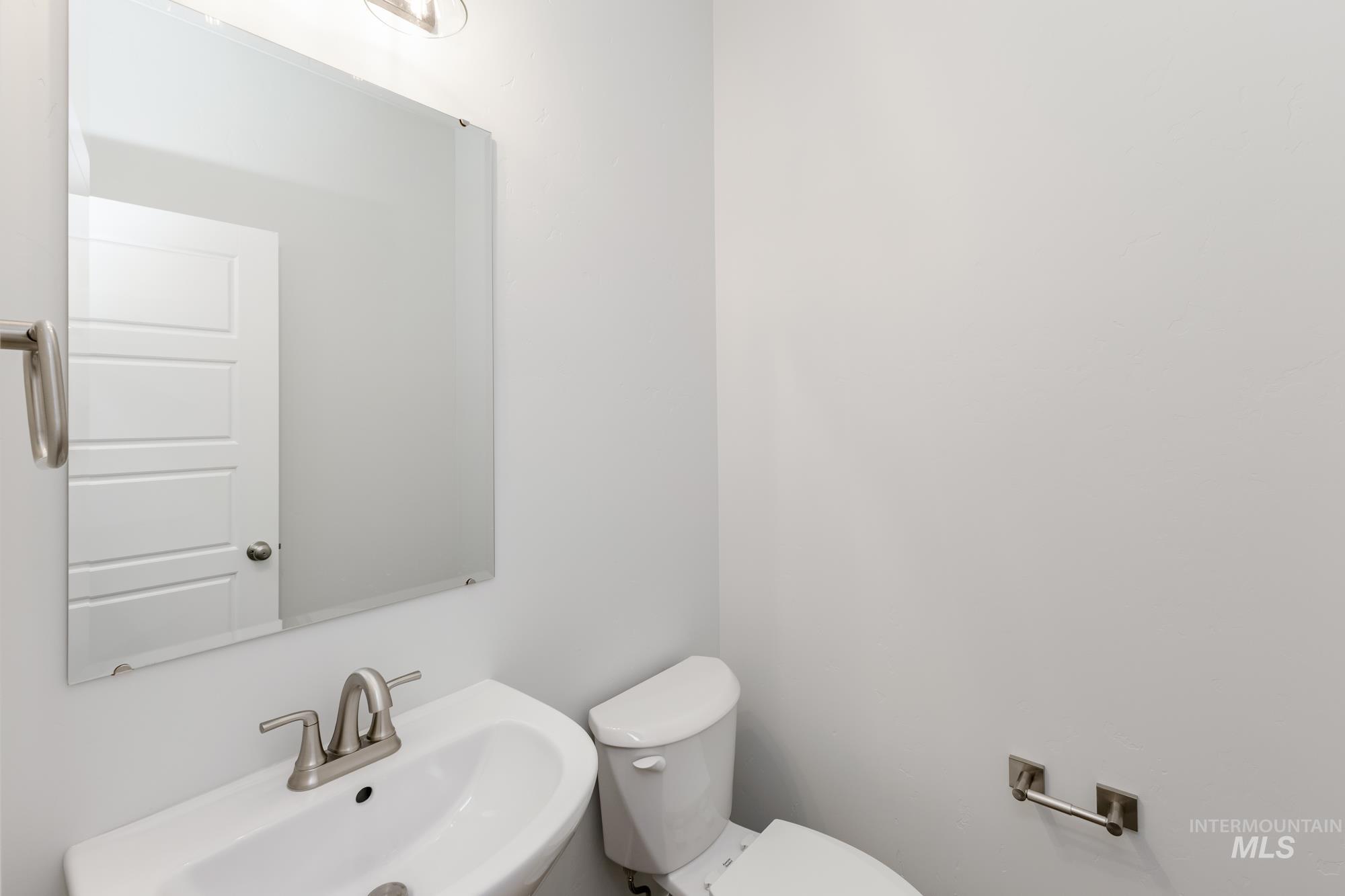 Half bathroom with a sink and toilet