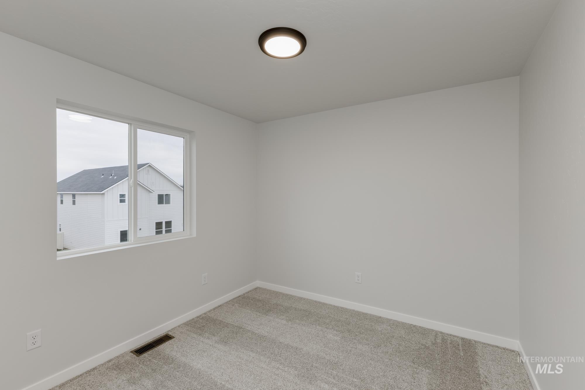 Unfurnished room with carpet flooring and baseboards