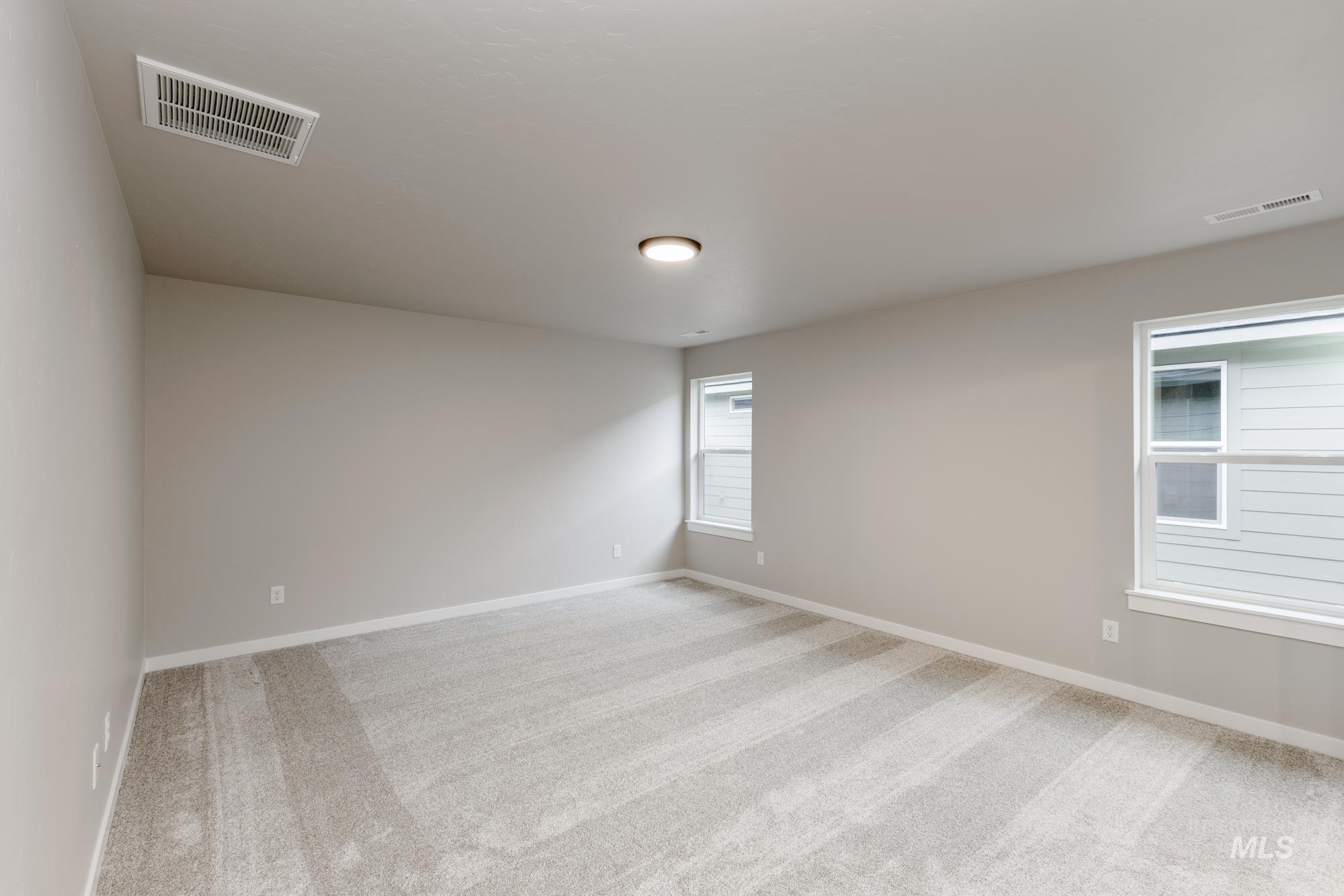 Unfurnished room with light carpet and baseboards
