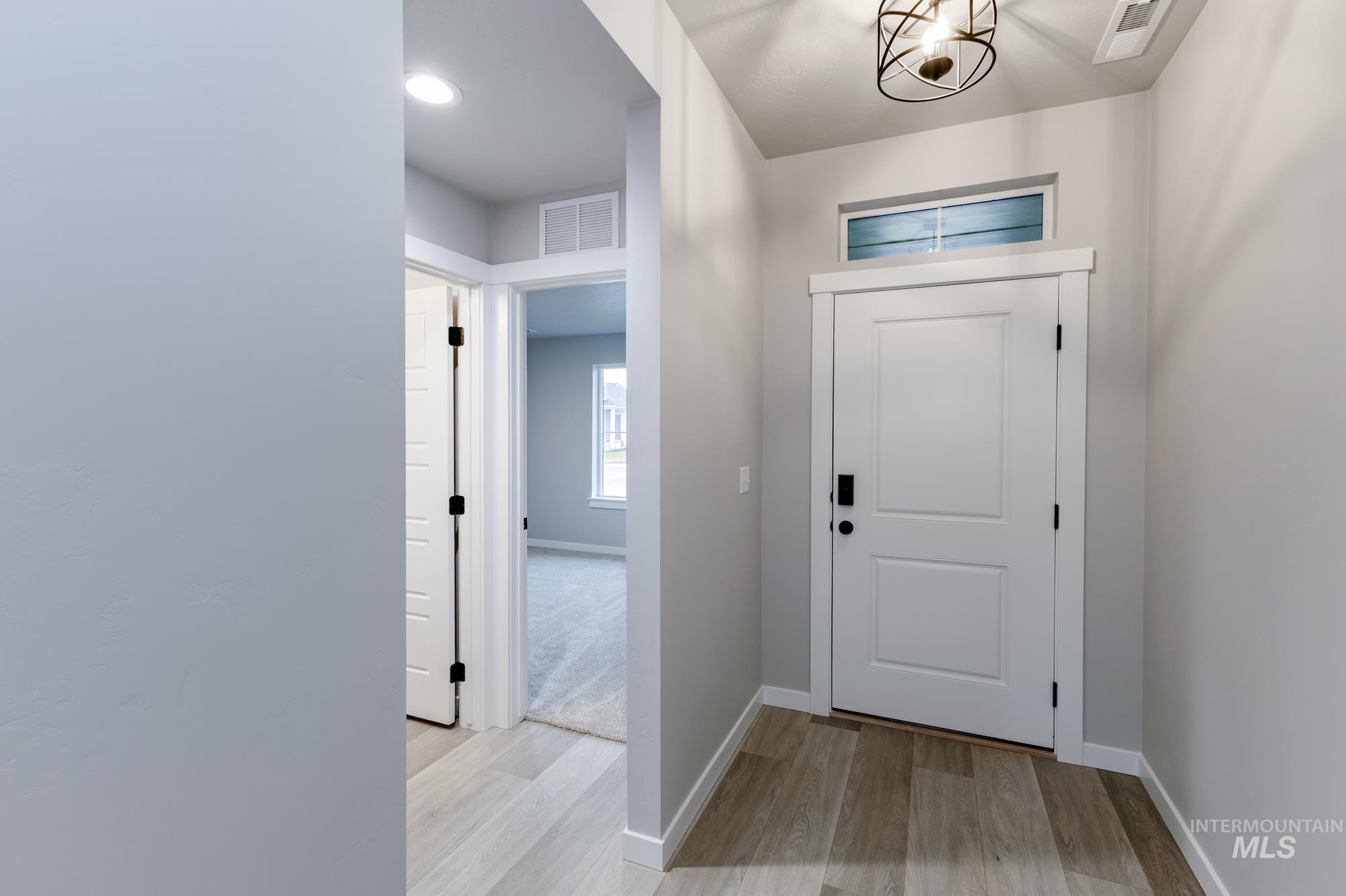 Entryway featuring light wood-type flooring and baseboards