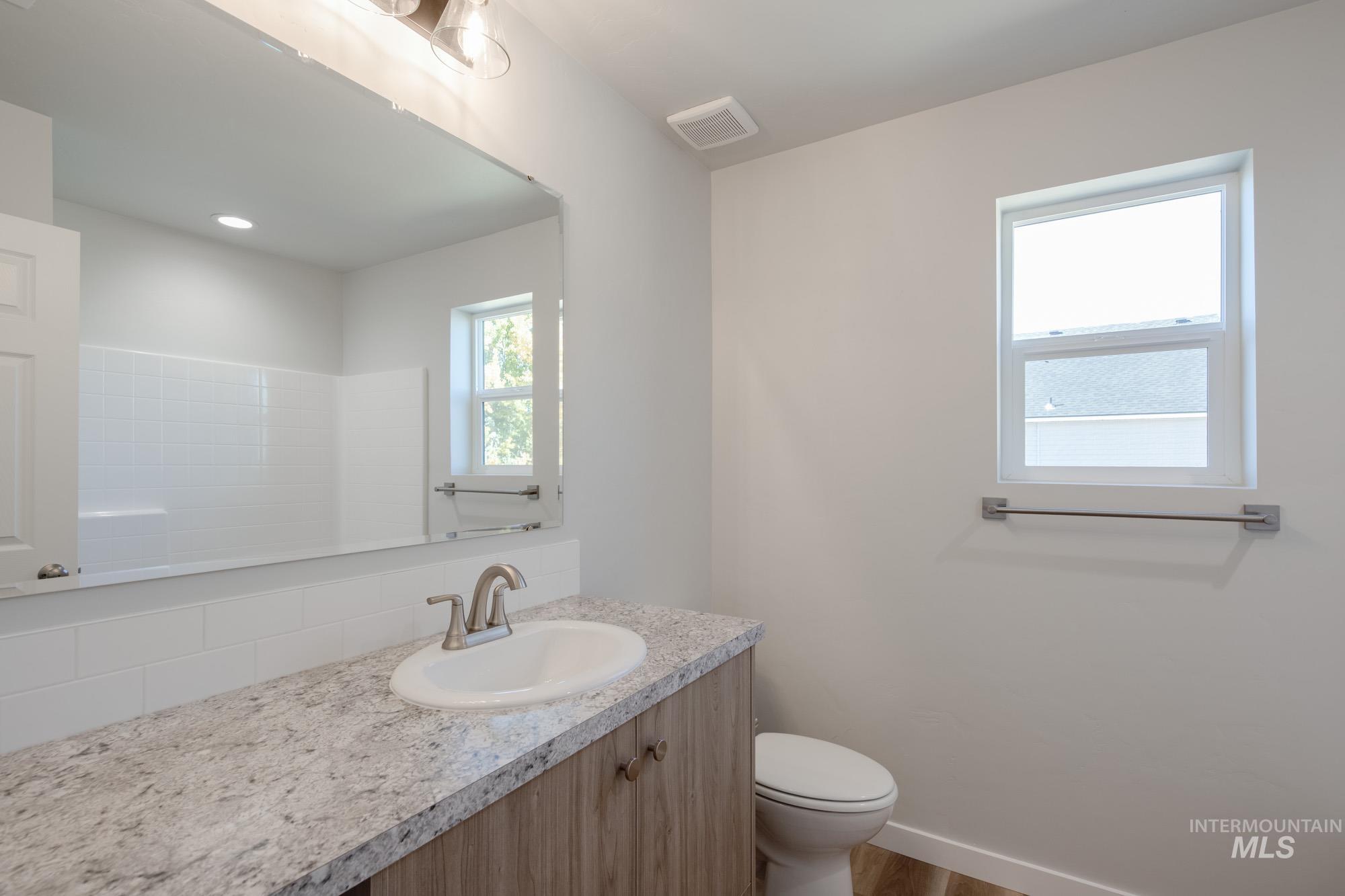 Bathroom featuring vanity and wood finished floors