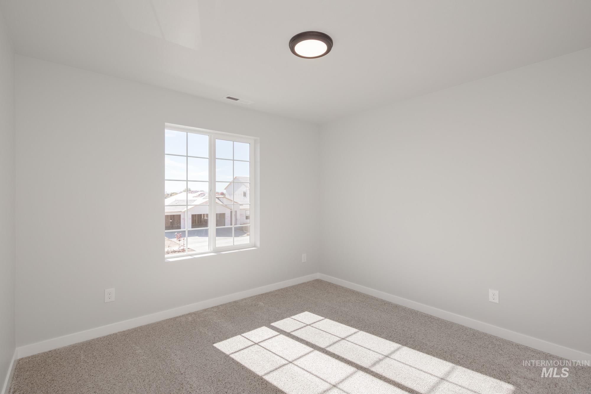 Empty room with baseboards and carpet flooring