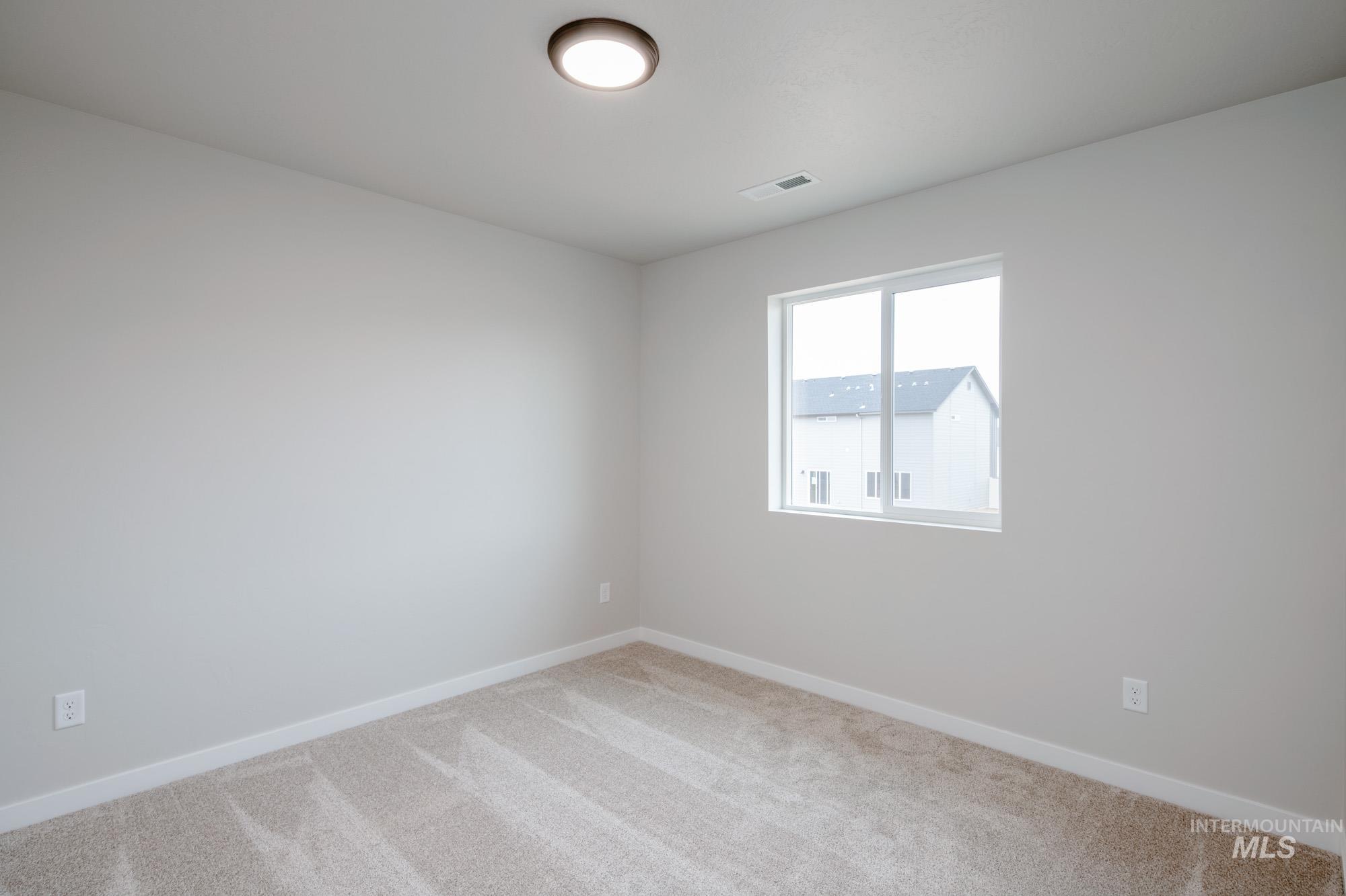 Empty room featuring baseboards and carpet flooring