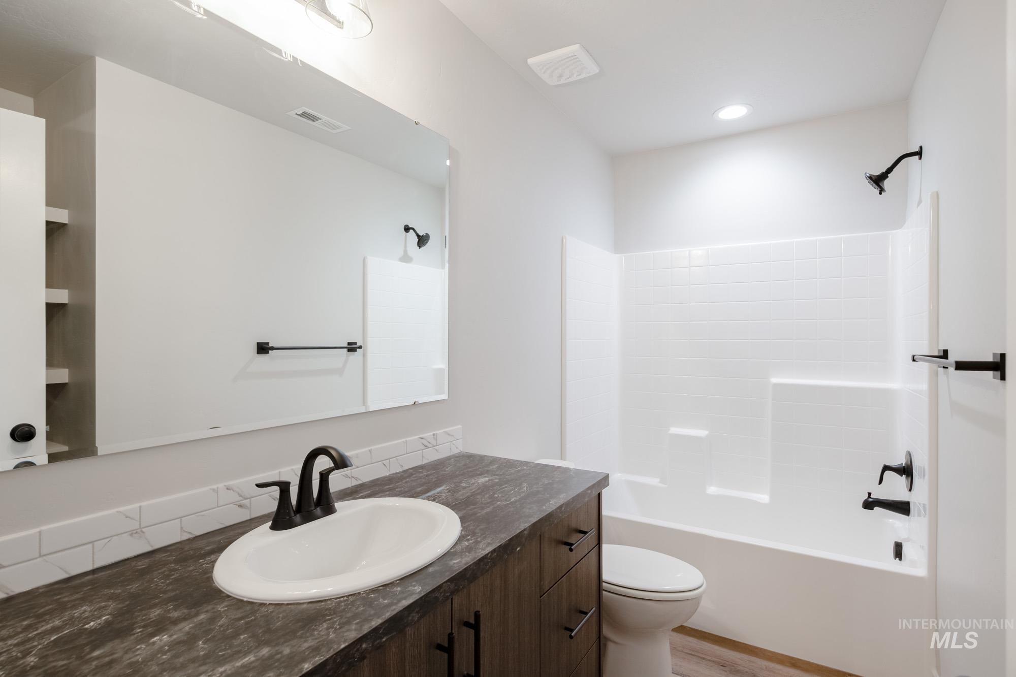 Full bath with vanity and shower / bathtub combination