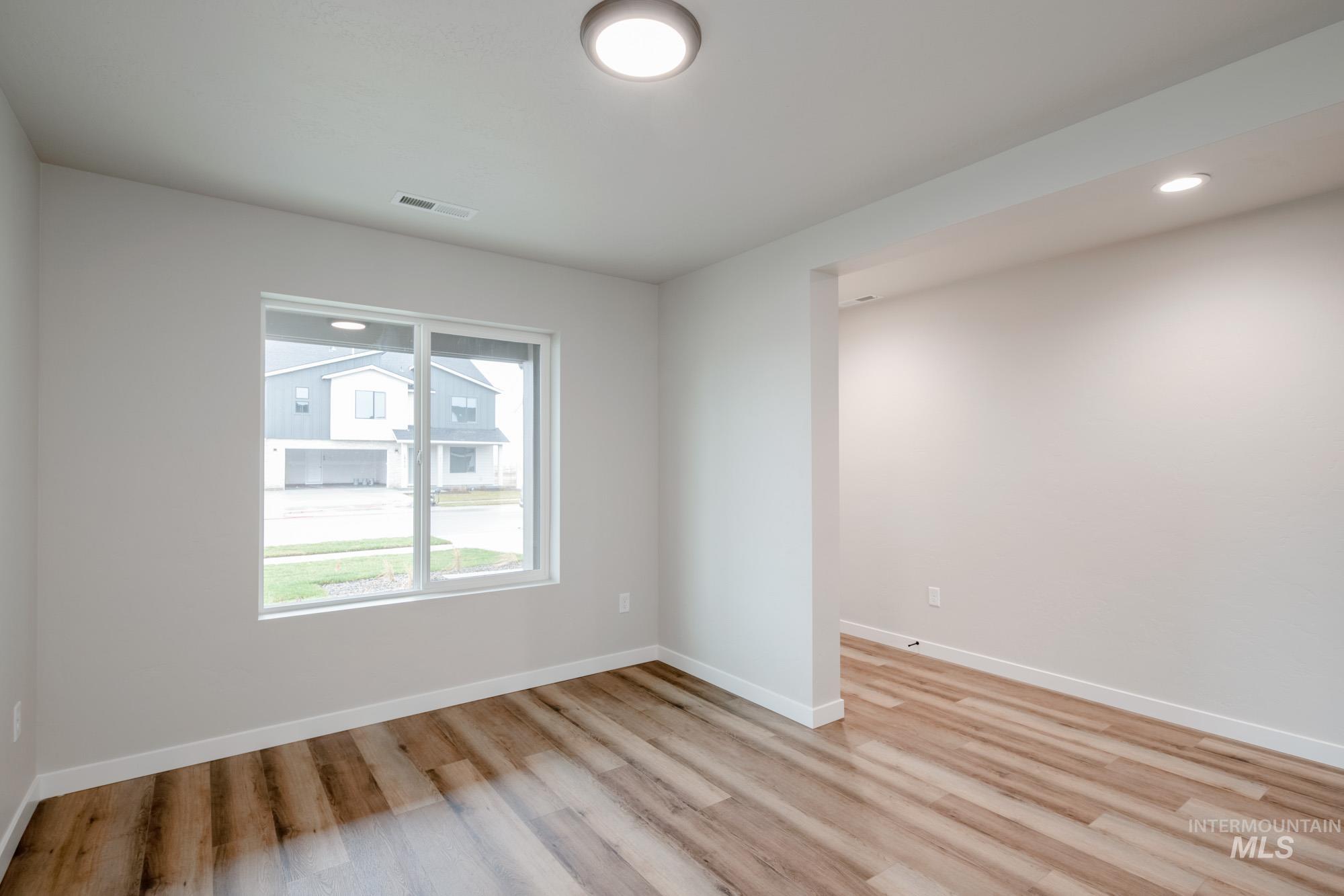 Empty room with recessed lighting and light wood finished floors