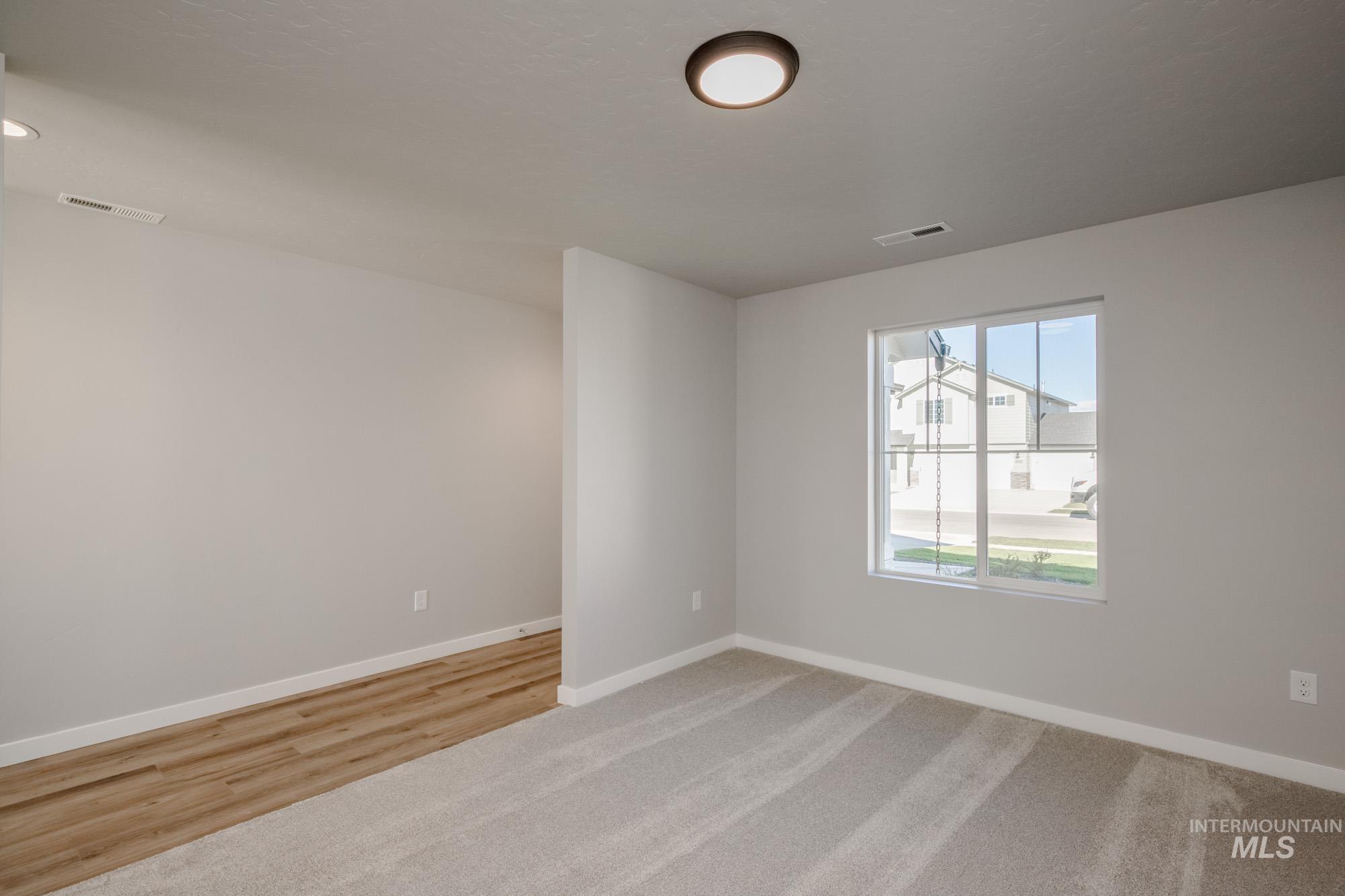Empty room with baseboards and light carpet