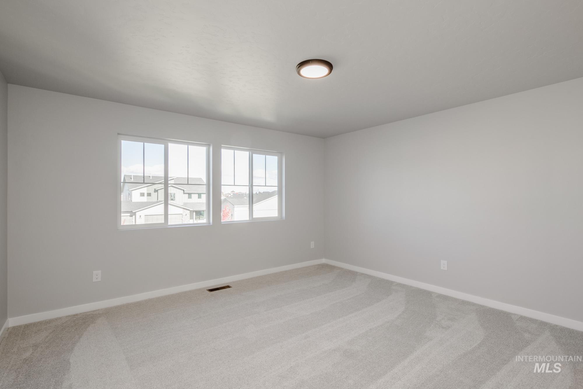 Unfurnished room featuring light colored carpet