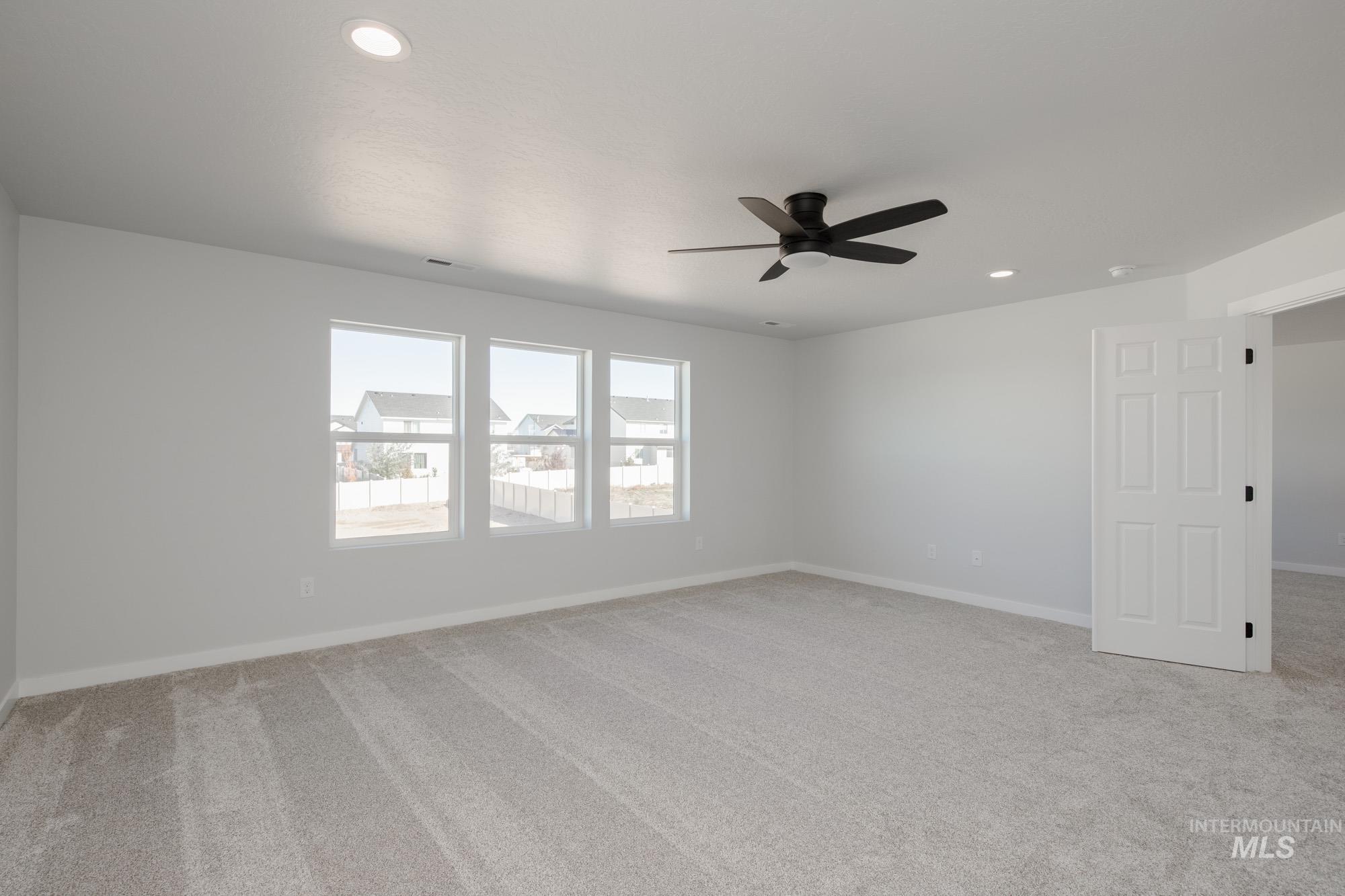 Unfurnished room featuring light carpet, recessed lighting, and ceiling fan