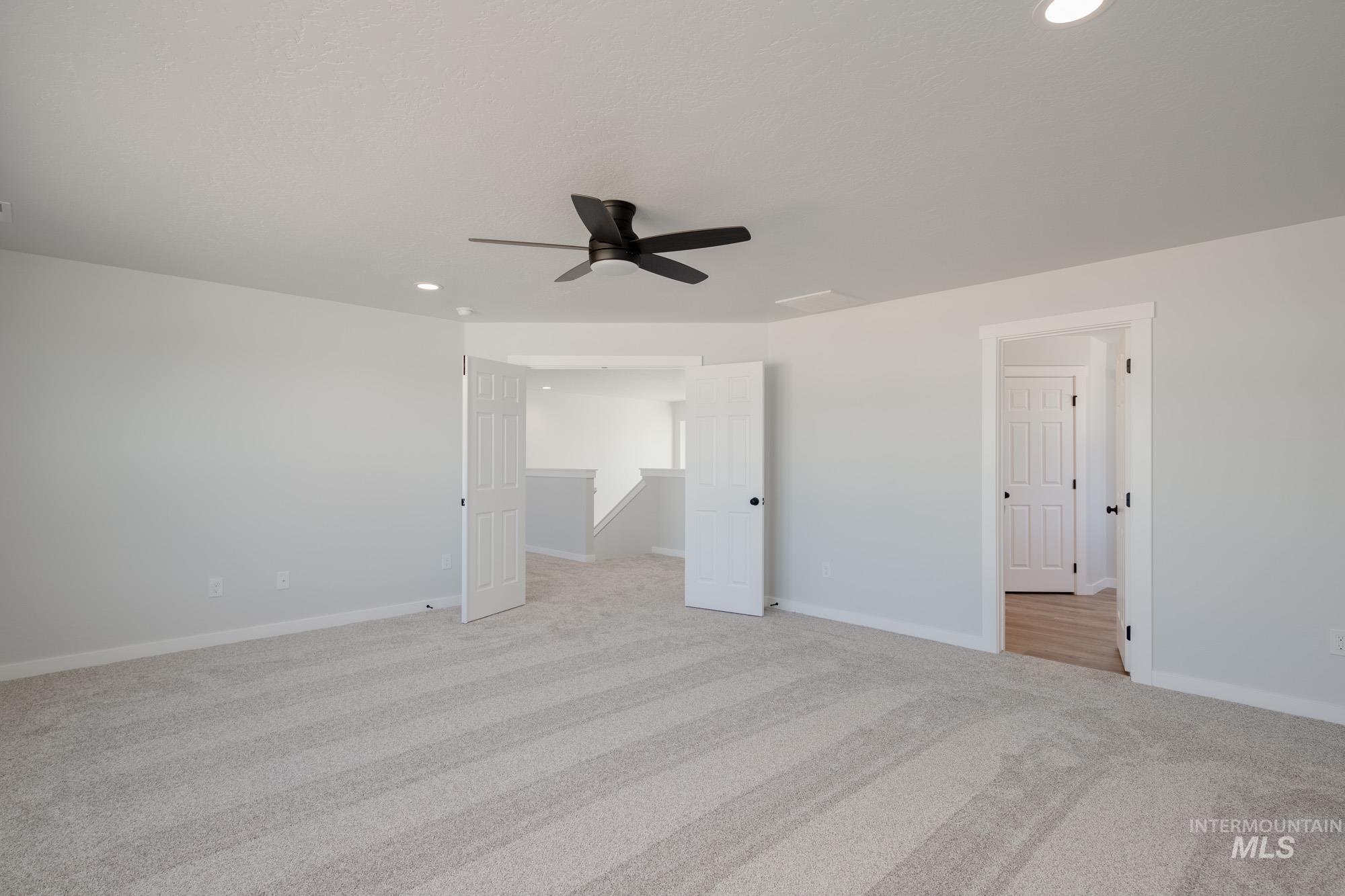 Unfurnished bedroom featuring a ceiling fan, light colored carpet, and recessed lighting