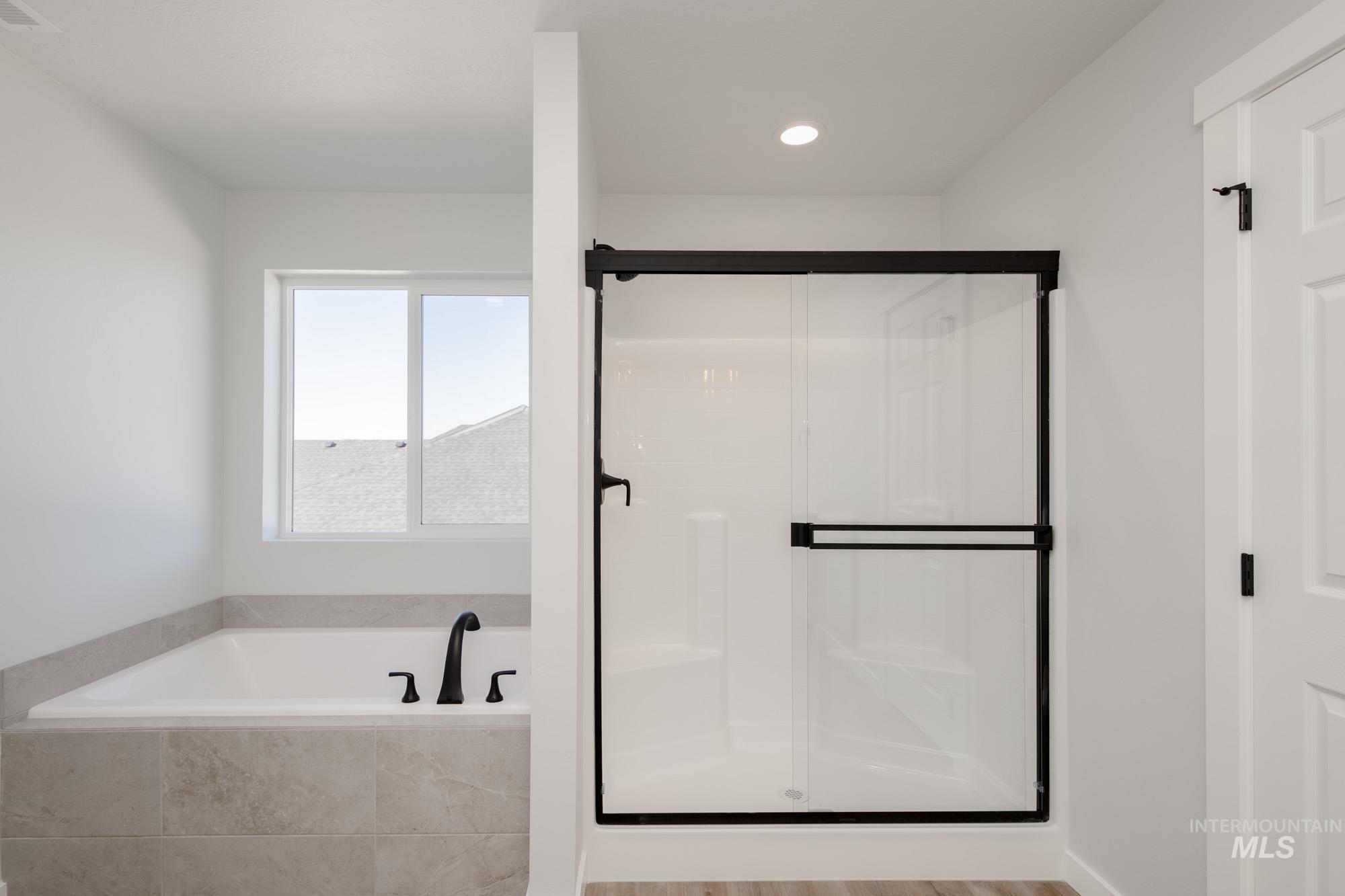 Full bath featuring a garden tub, a shower stall, and recessed lighting