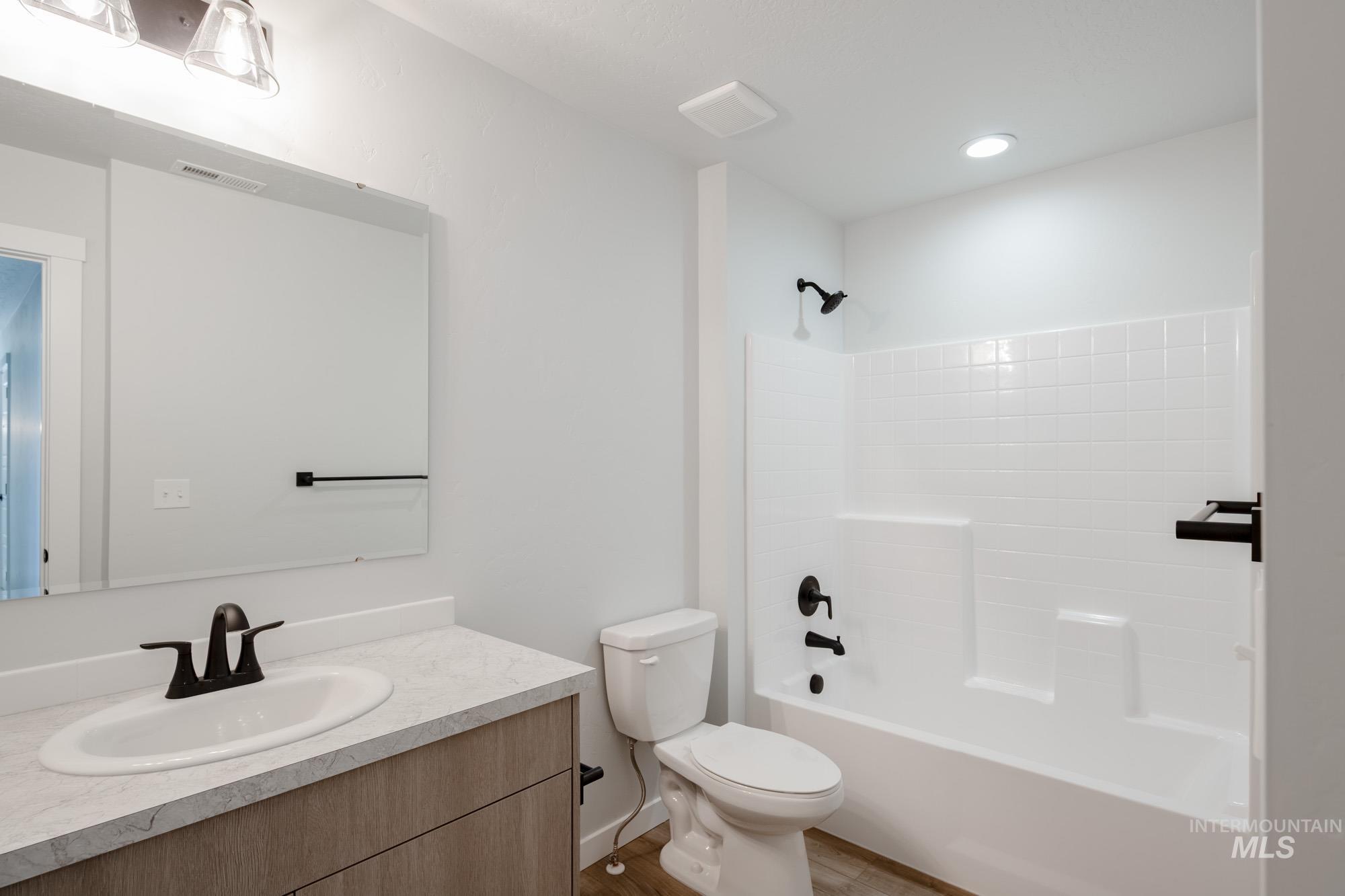 Bathroom featuring tub / shower combination and vanity