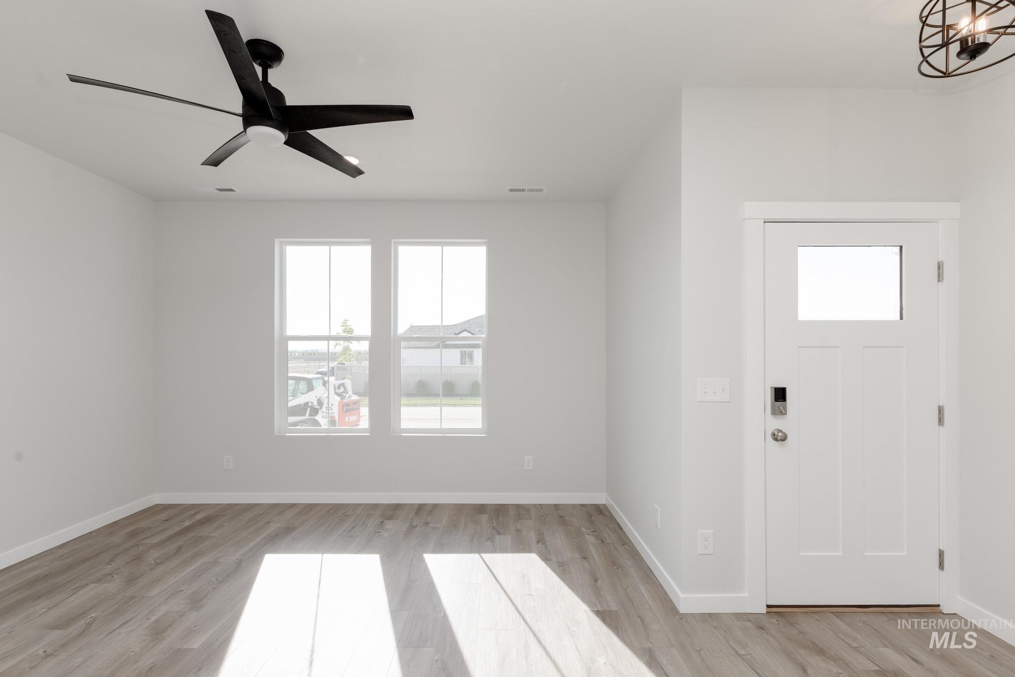 Foyer with light wood-style floors and ceiling fan