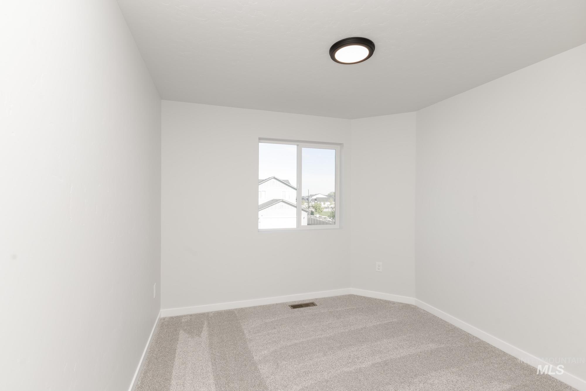 Unfurnished room with light carpet and baseboards