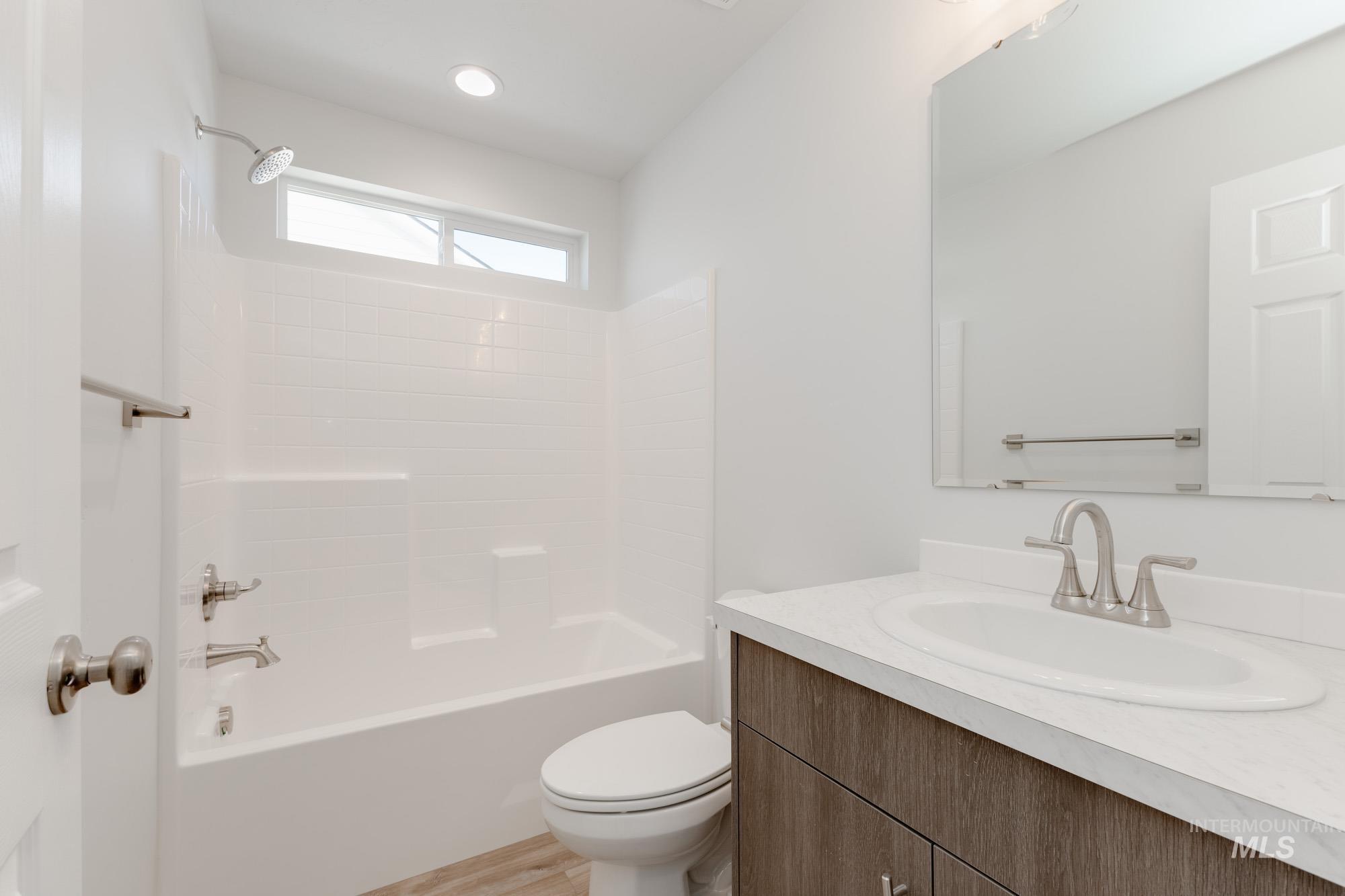 Full bathroom featuring shower / bath combination and vanity