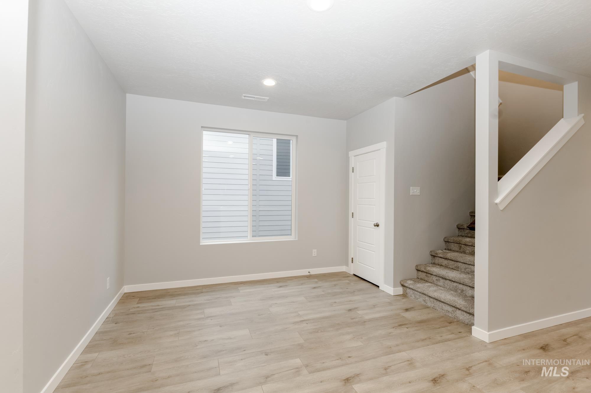 Foyer featuring stairway and light wood-type flooring