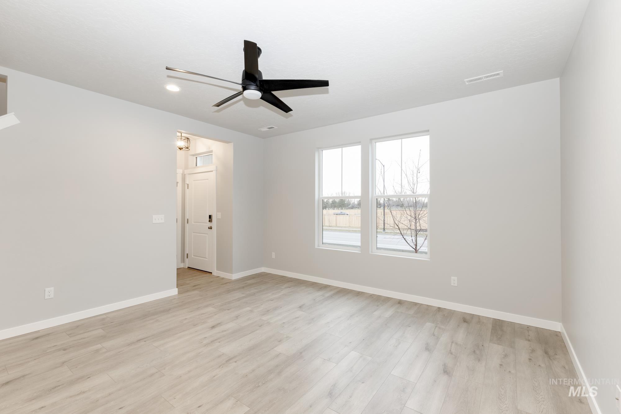Spare room featuring light wood-style floors and a ceiling fan
