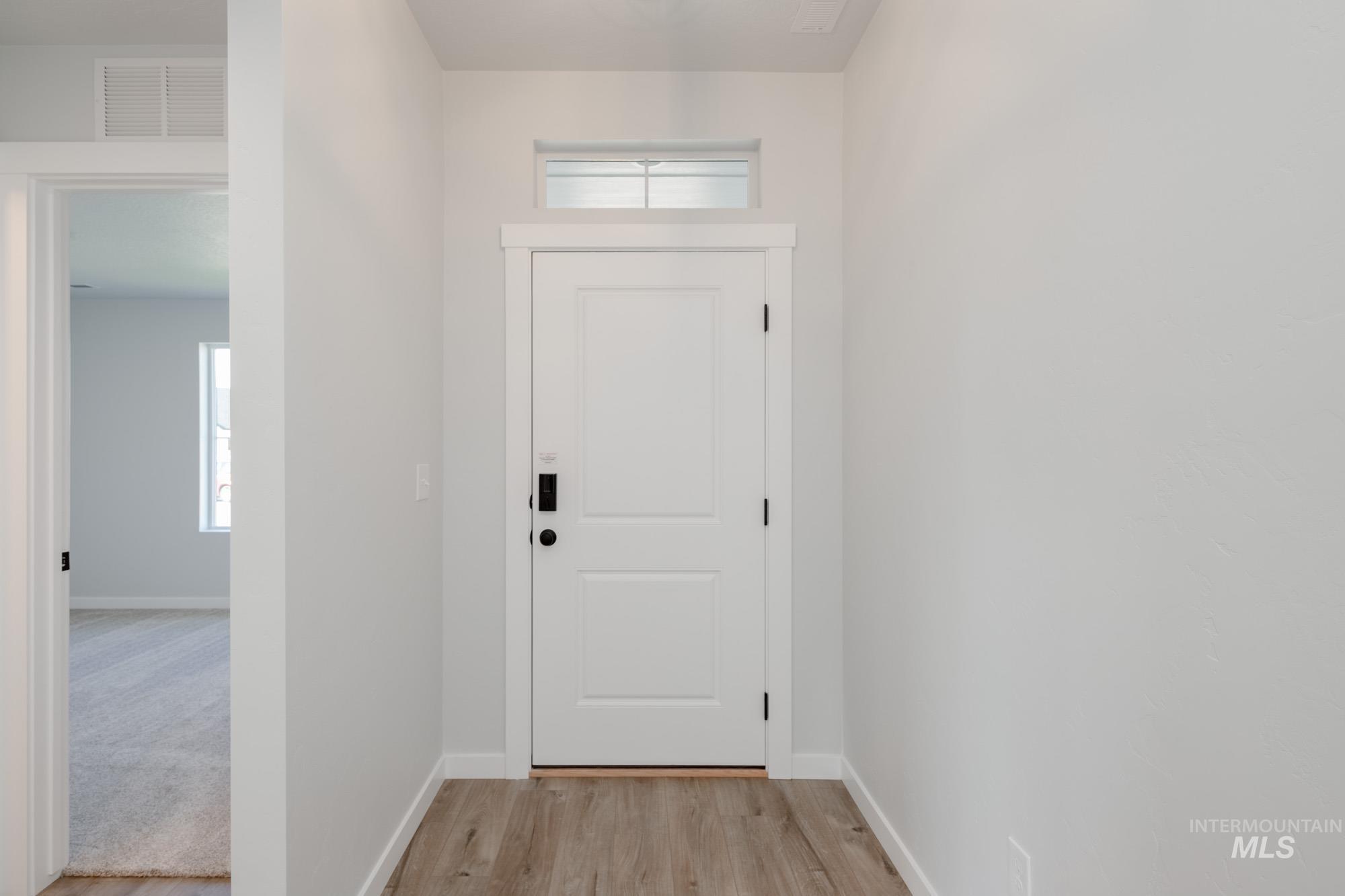Entryway featuring healthy amount of natural light and wood finished floors