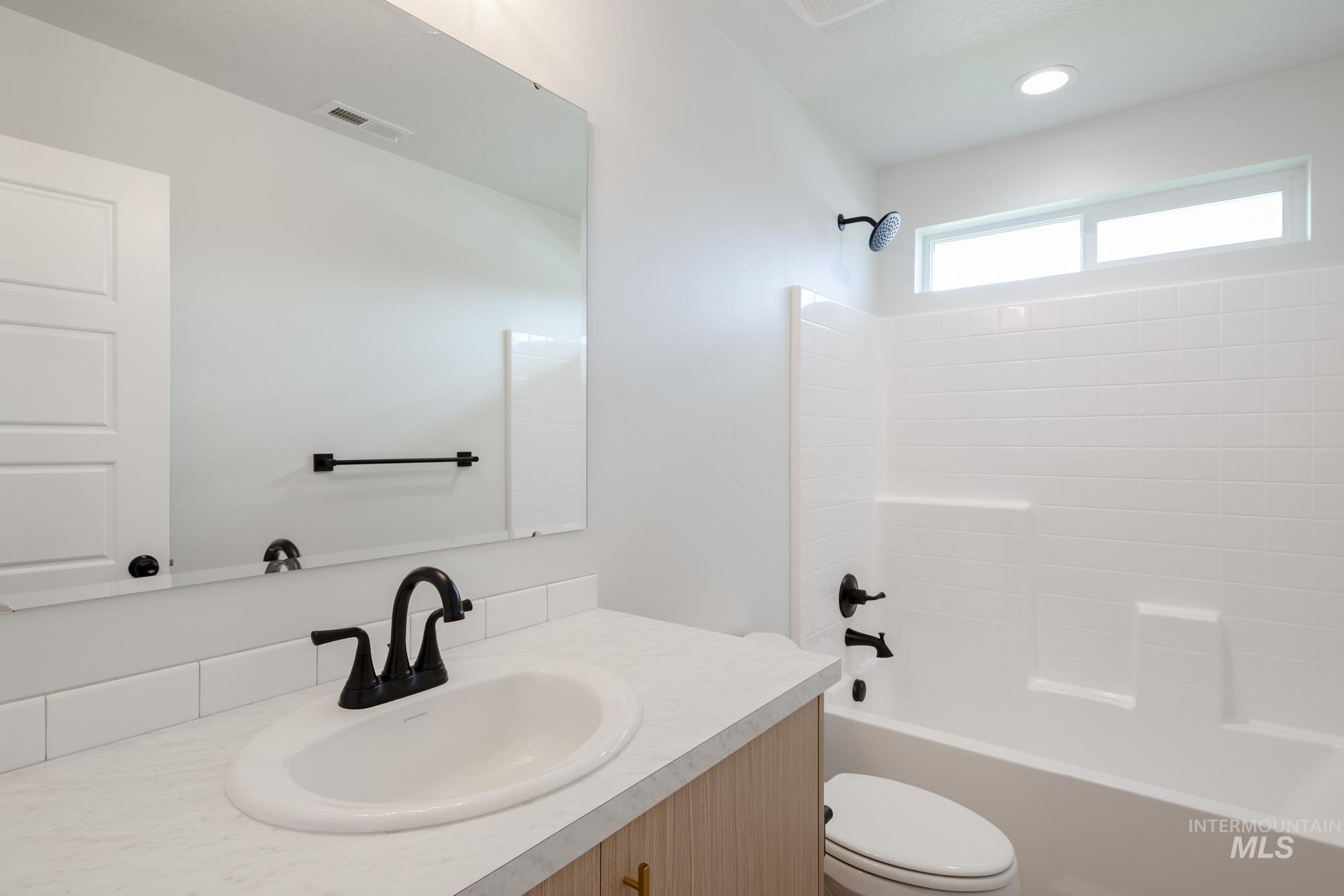 Bathroom featuring shower / washtub combination and vanity