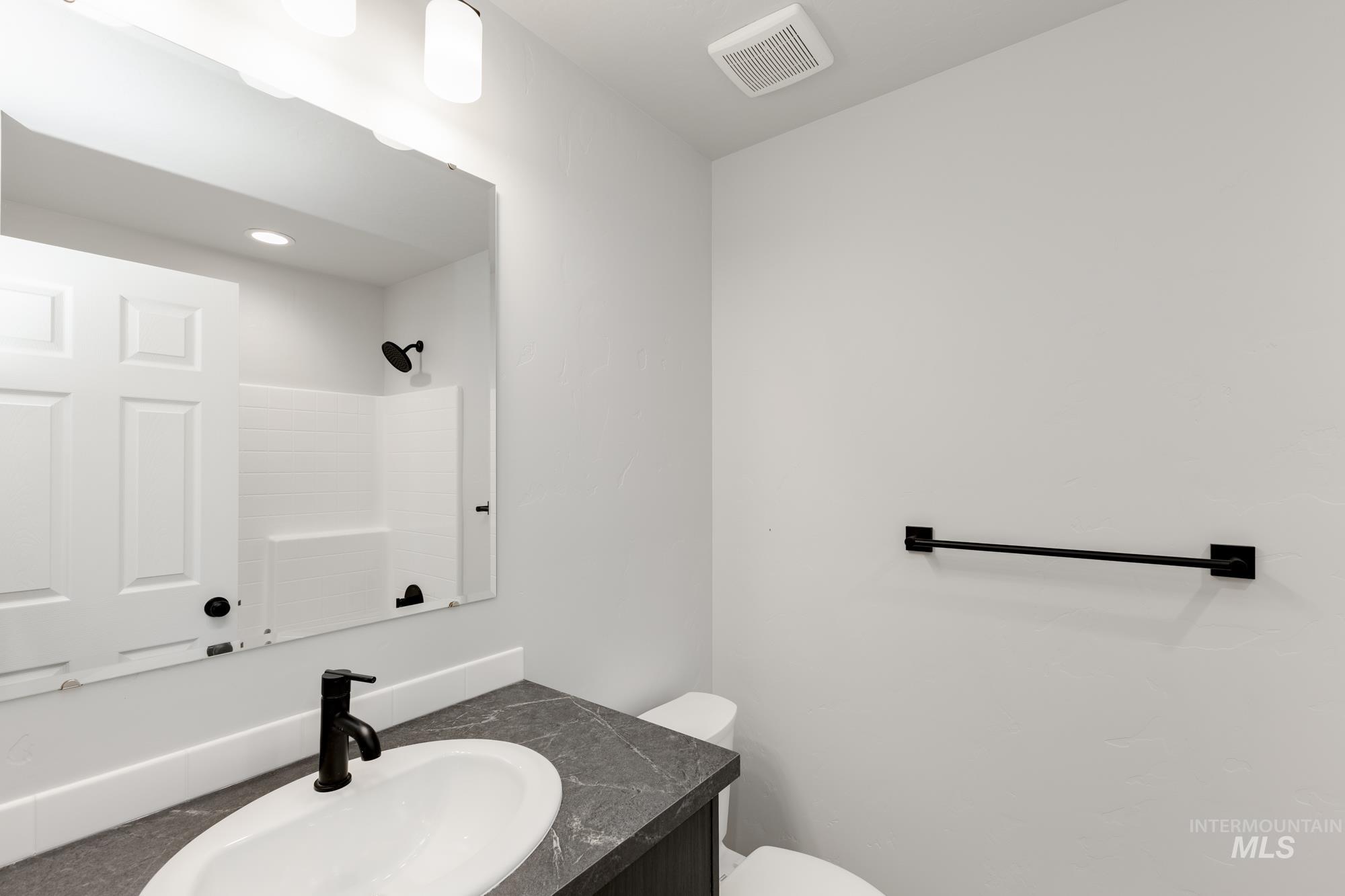 Full bathroom with vanity and a shower