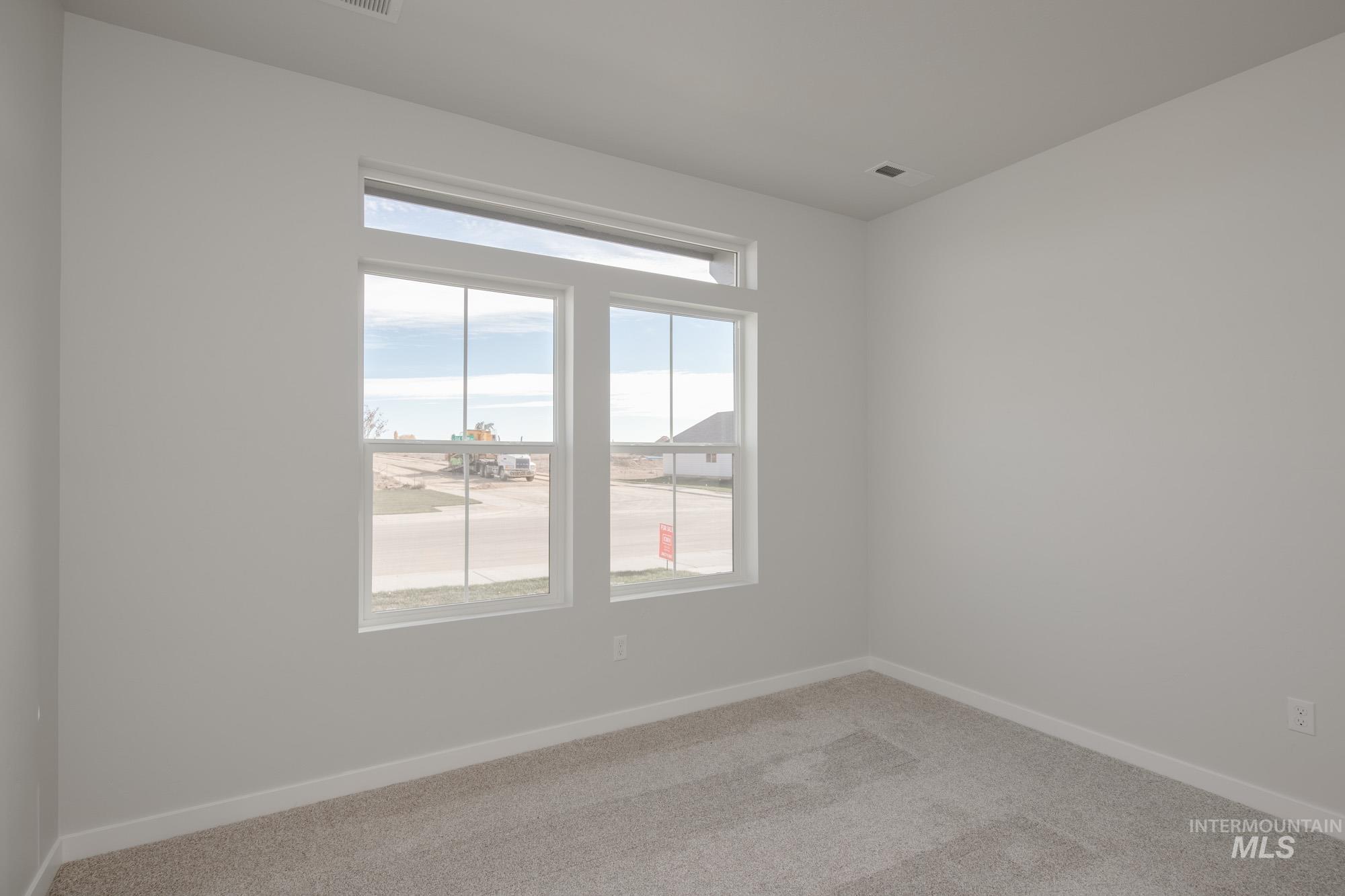 Unfurnished room with baseboards and carpet floors