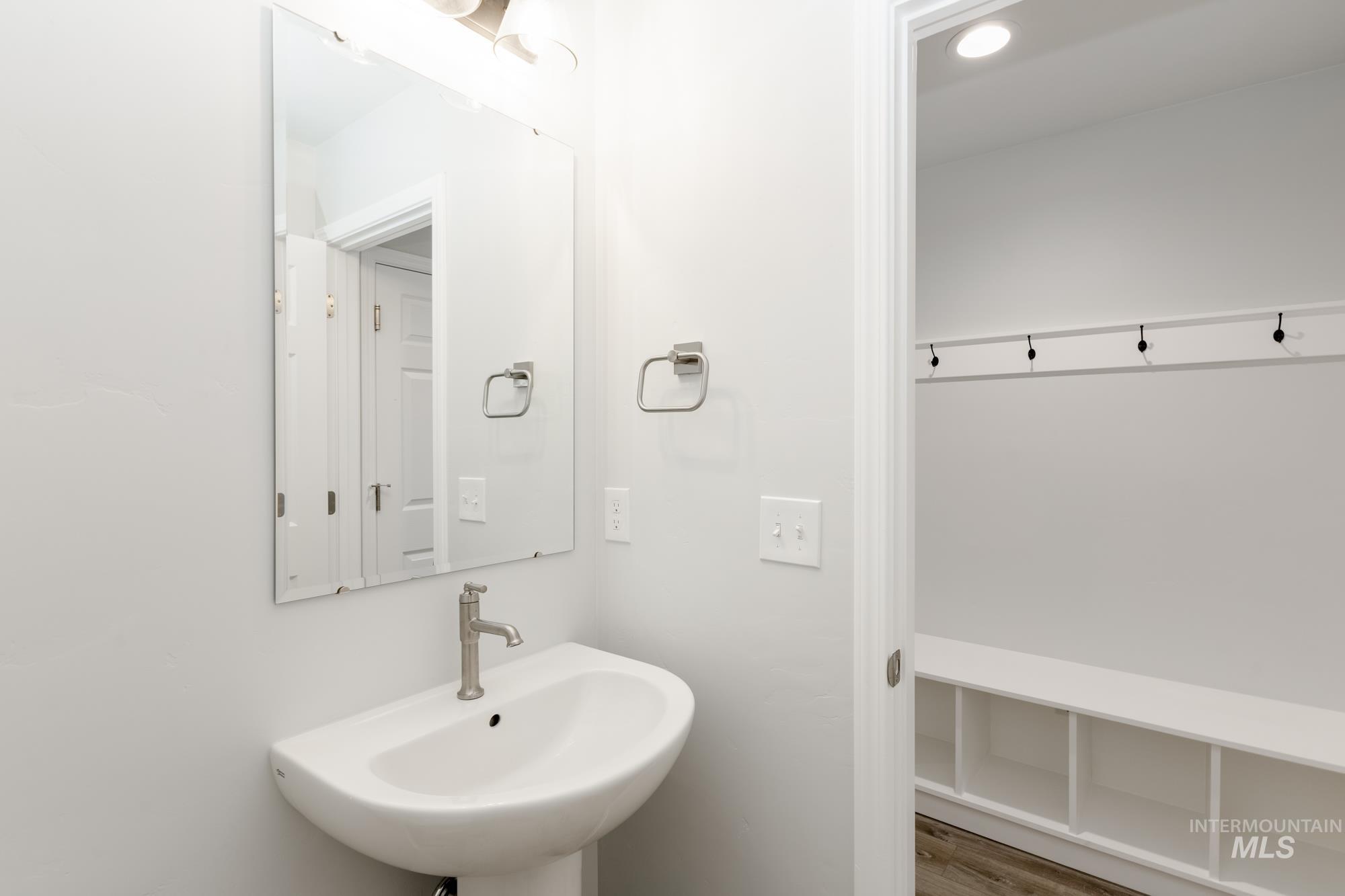 Bathroom with wood finished floors and a sink