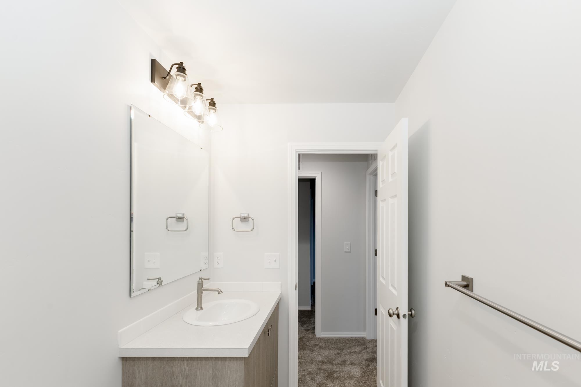 Bathroom with vanity and carpet flooring