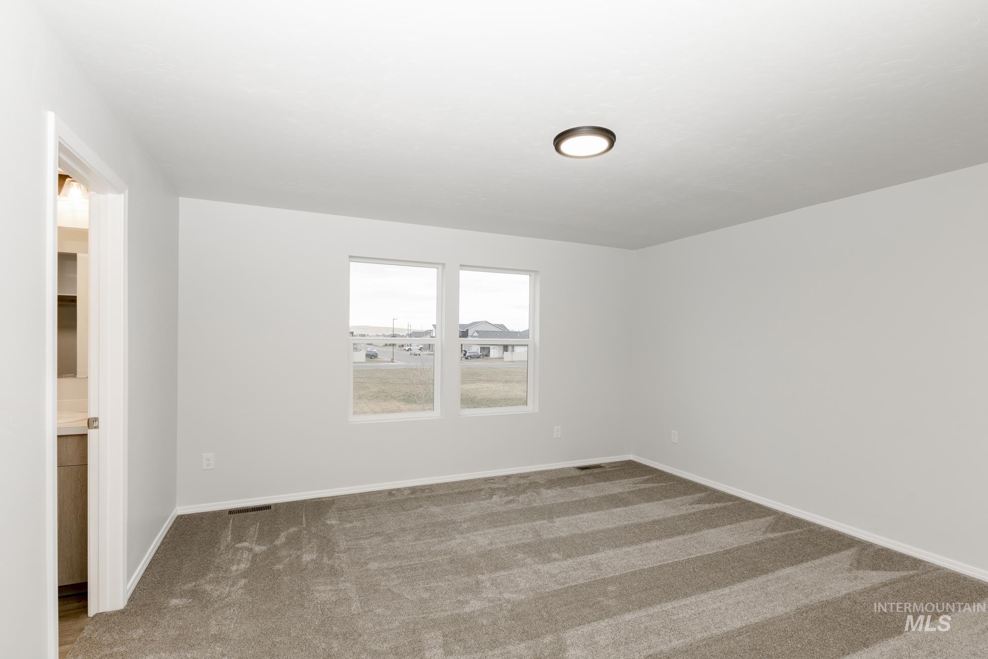 Unfurnished room with carpet and baseboards