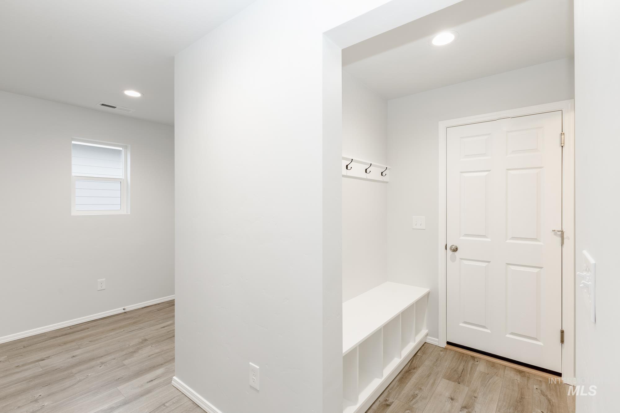 Mudroom with light wood-type flooring and recessed lighting