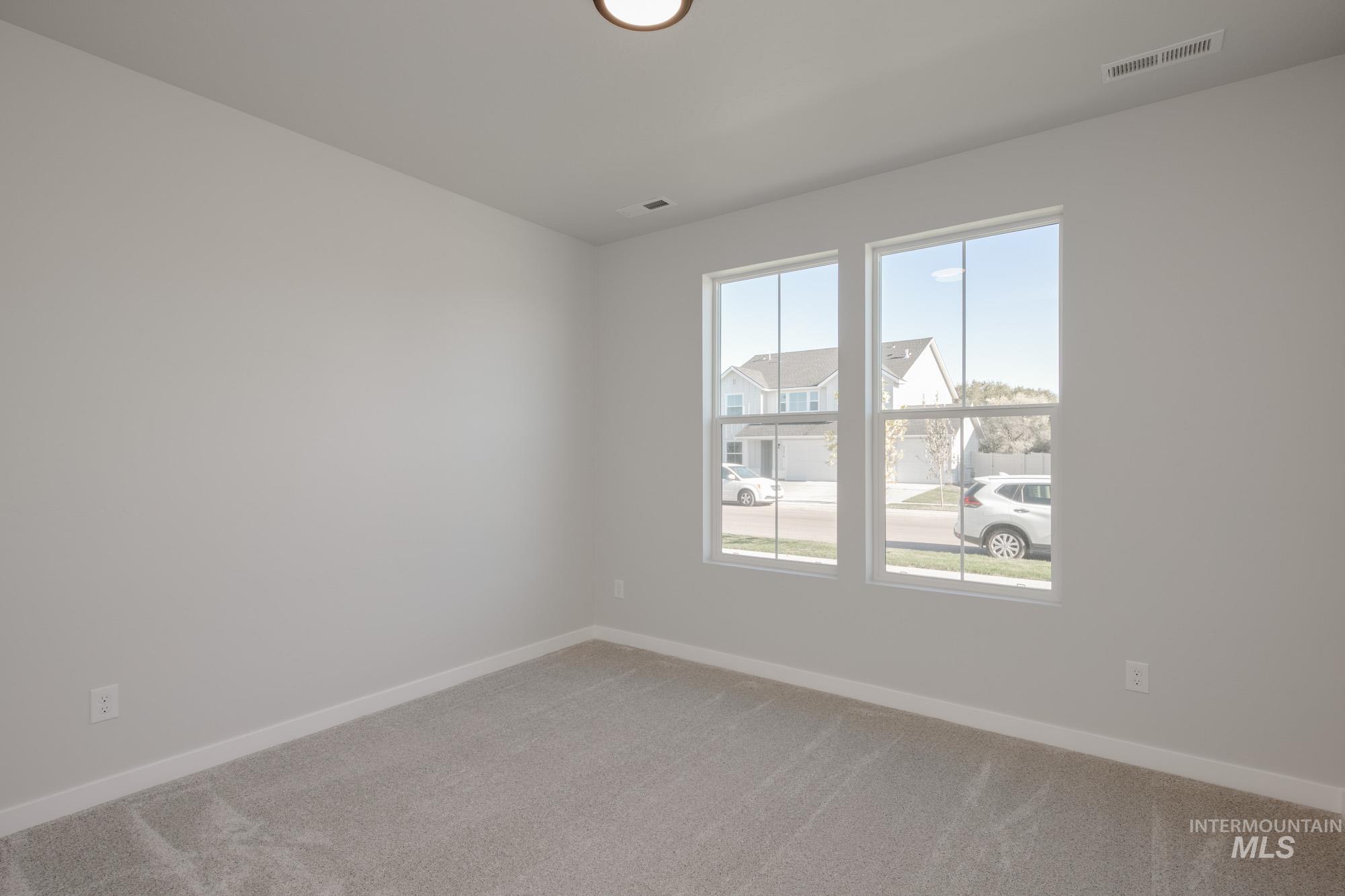 Empty room with baseboards and light carpet
