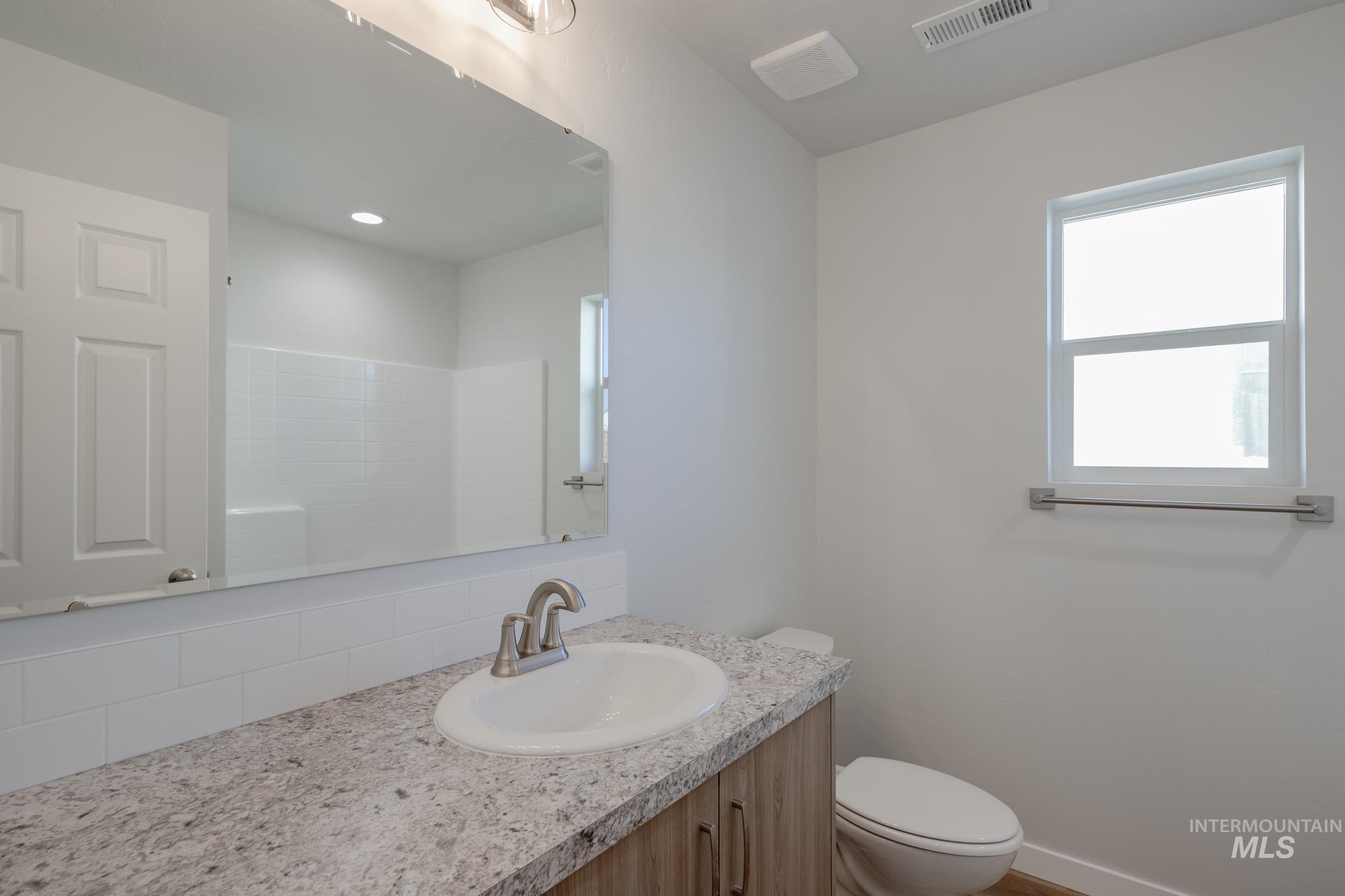 Full bathroom with vanity and a shower