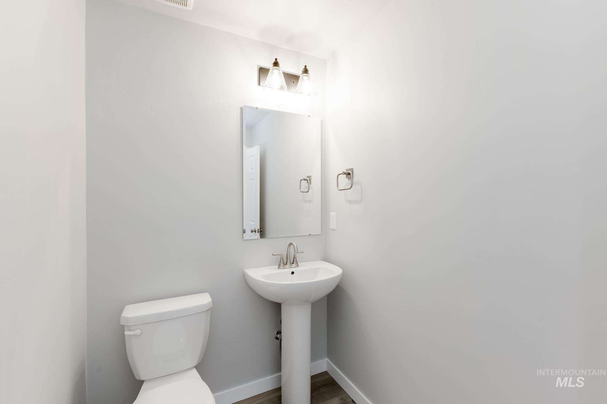 Bathroom featuring toilet and baseboards