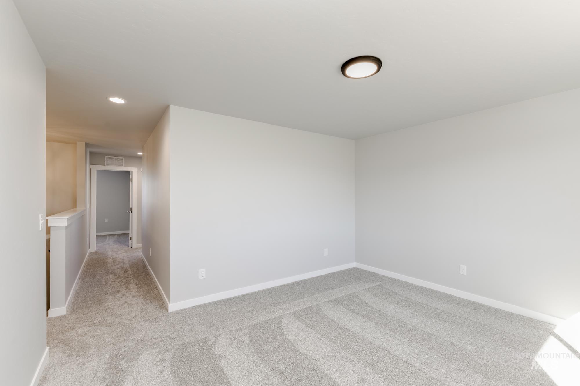 Unfurnished room featuring light carpet and recessed lighting