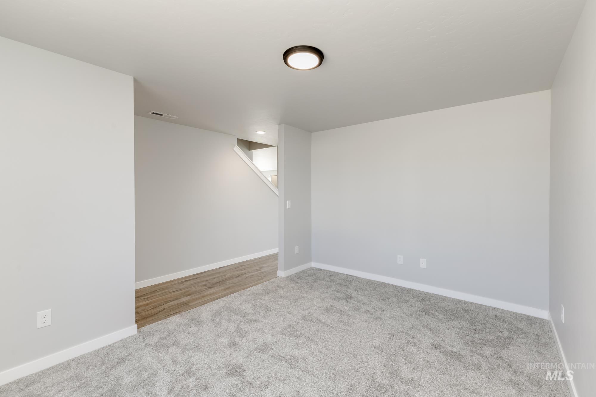 Unfurnished room with carpet floors and baseboards