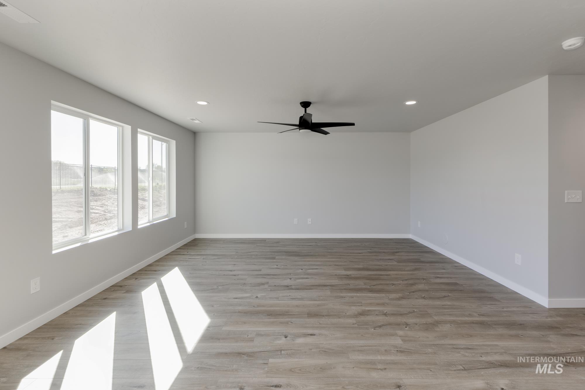 Spare room featuring light wood-style floors, recessed lighting, and ceiling fan