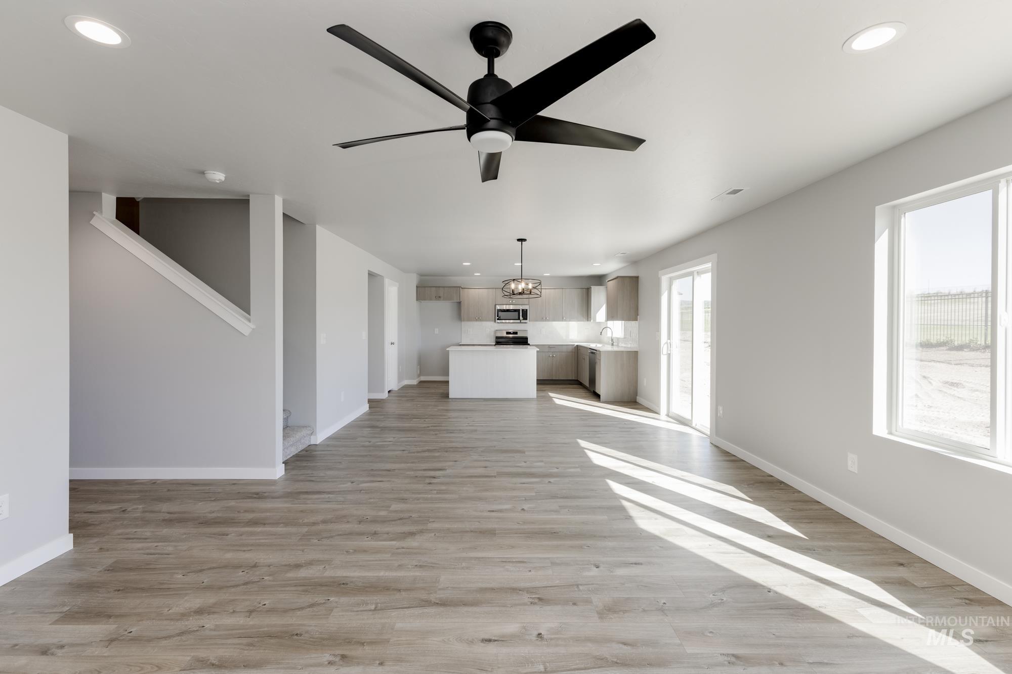 Unfurnished living room with recessed lighting, ceiling fan, and light wood-style floors