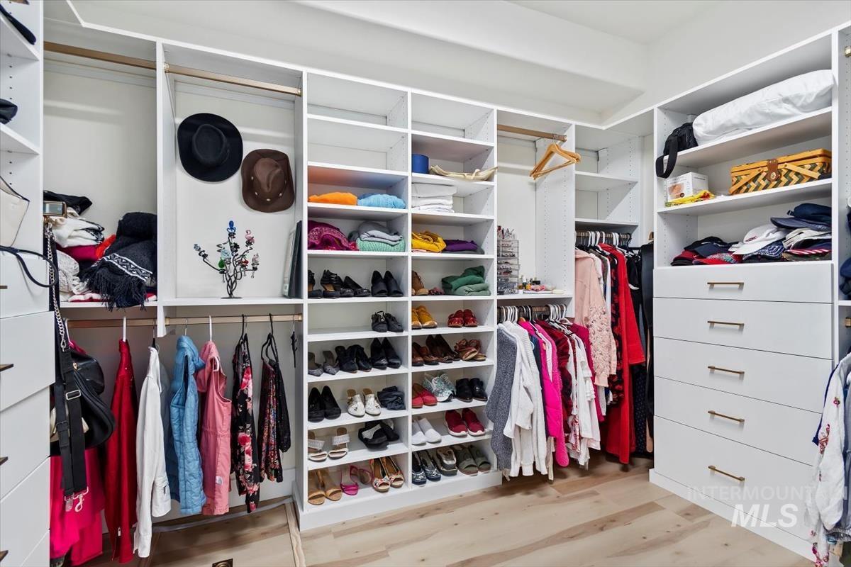 Spacious closet featuring light wood-type flooring