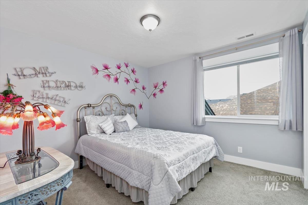 Bedroom with carpet floors and baseboards