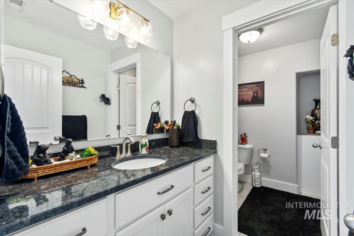 Bathroom featuring vanity and toilet