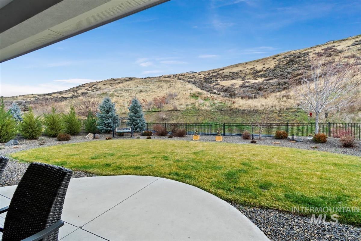 View of yard with a patio and a mountain view