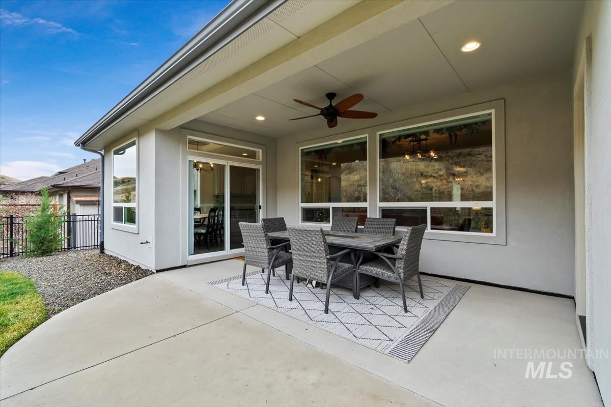 View of patio featuring outdoor dining area and a ceiling fan