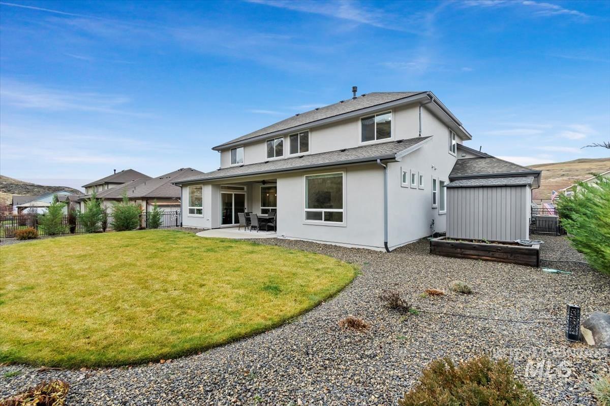 Back of house with a patio area, stucco siding, and a fenced backyard